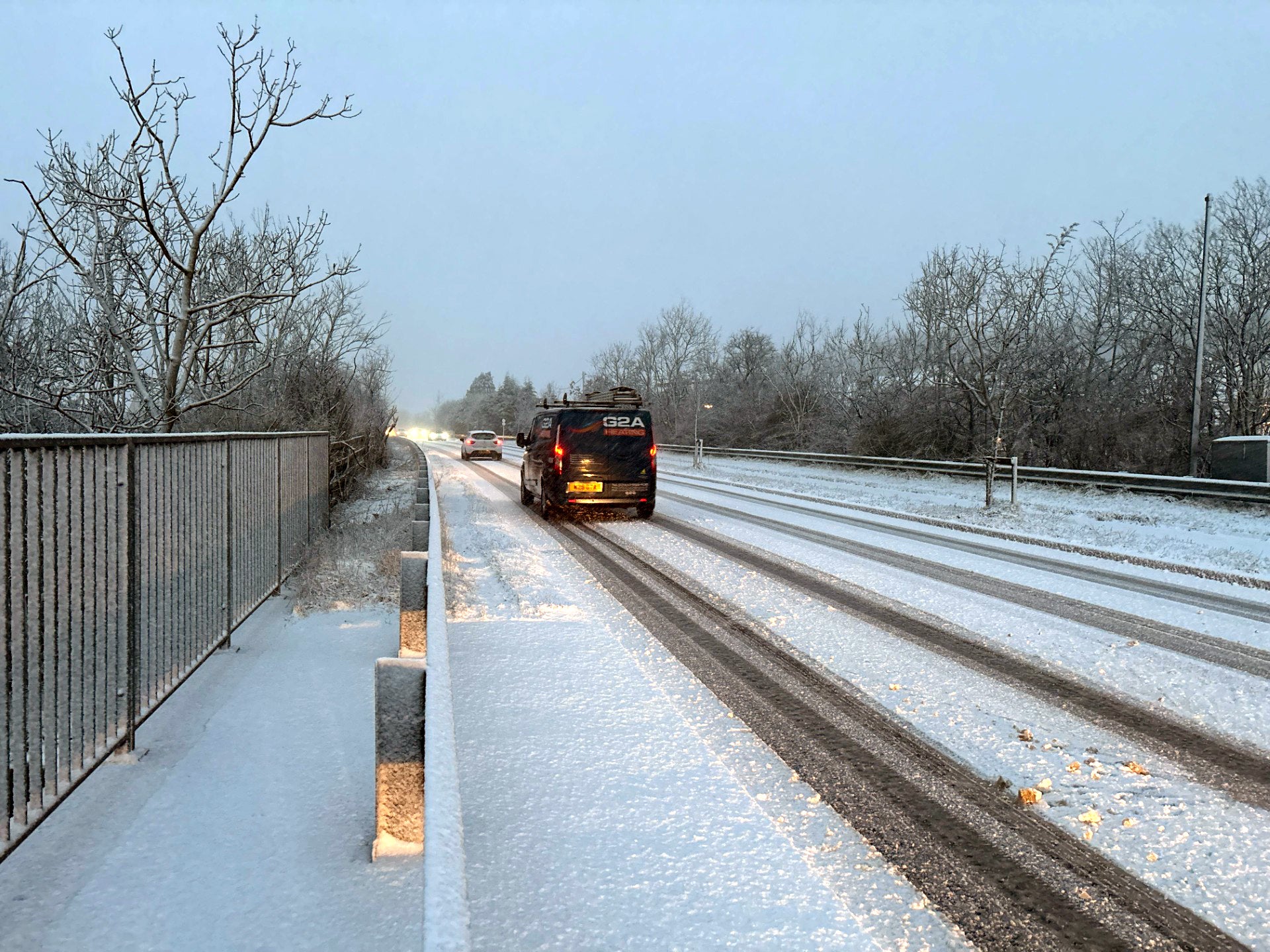 <p>Vehicles drive through snowy conditions in Rassau</p>