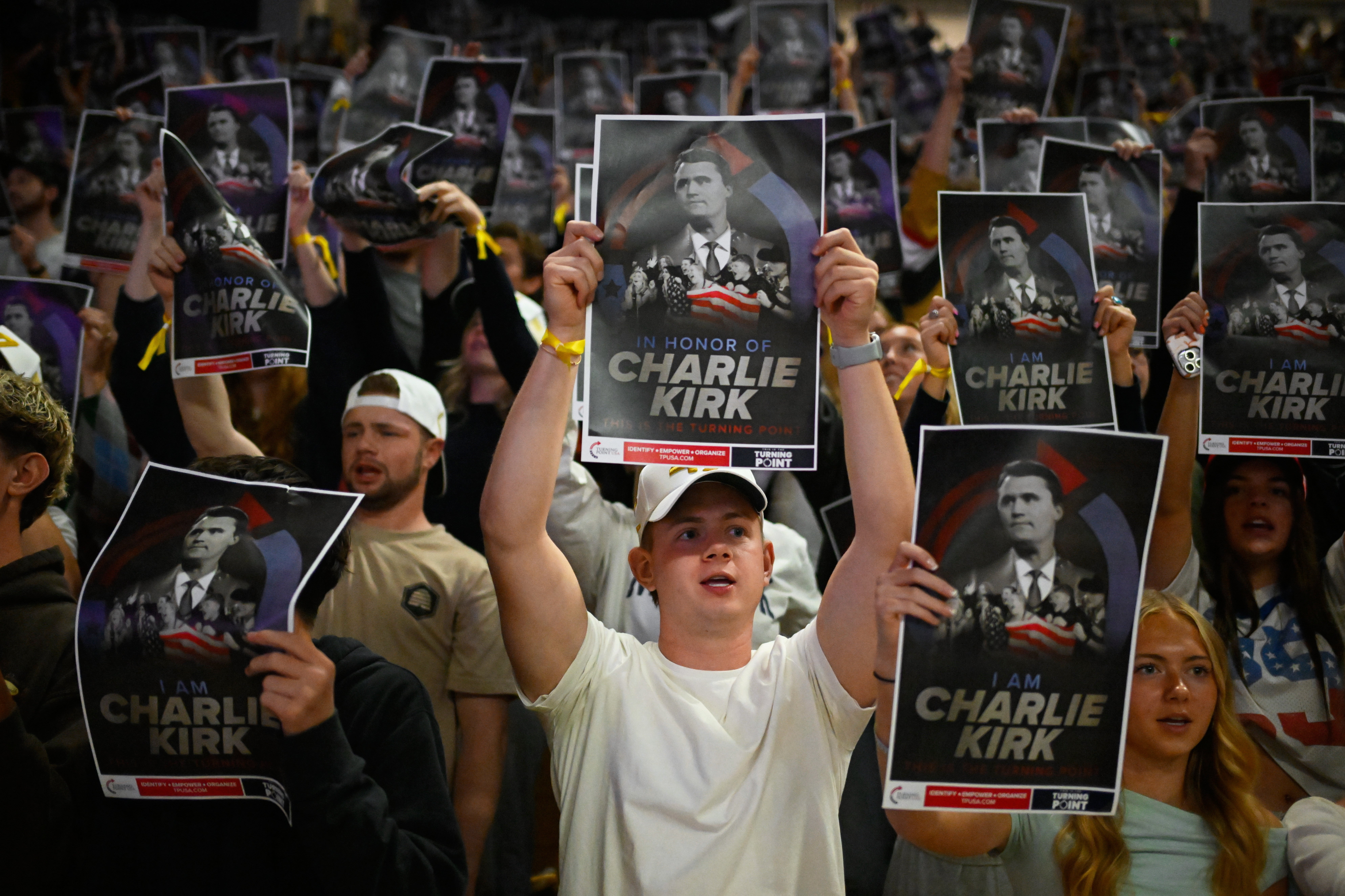 <p>People hold posters of Charlie Kirk during a Turning Point USA rally at Utah State University, as a part of the organization's push to memorialize Kirk, Sept. 30, 2025, in Logan, Utah. (AP Photo/Alex Goodlett, File)</p>