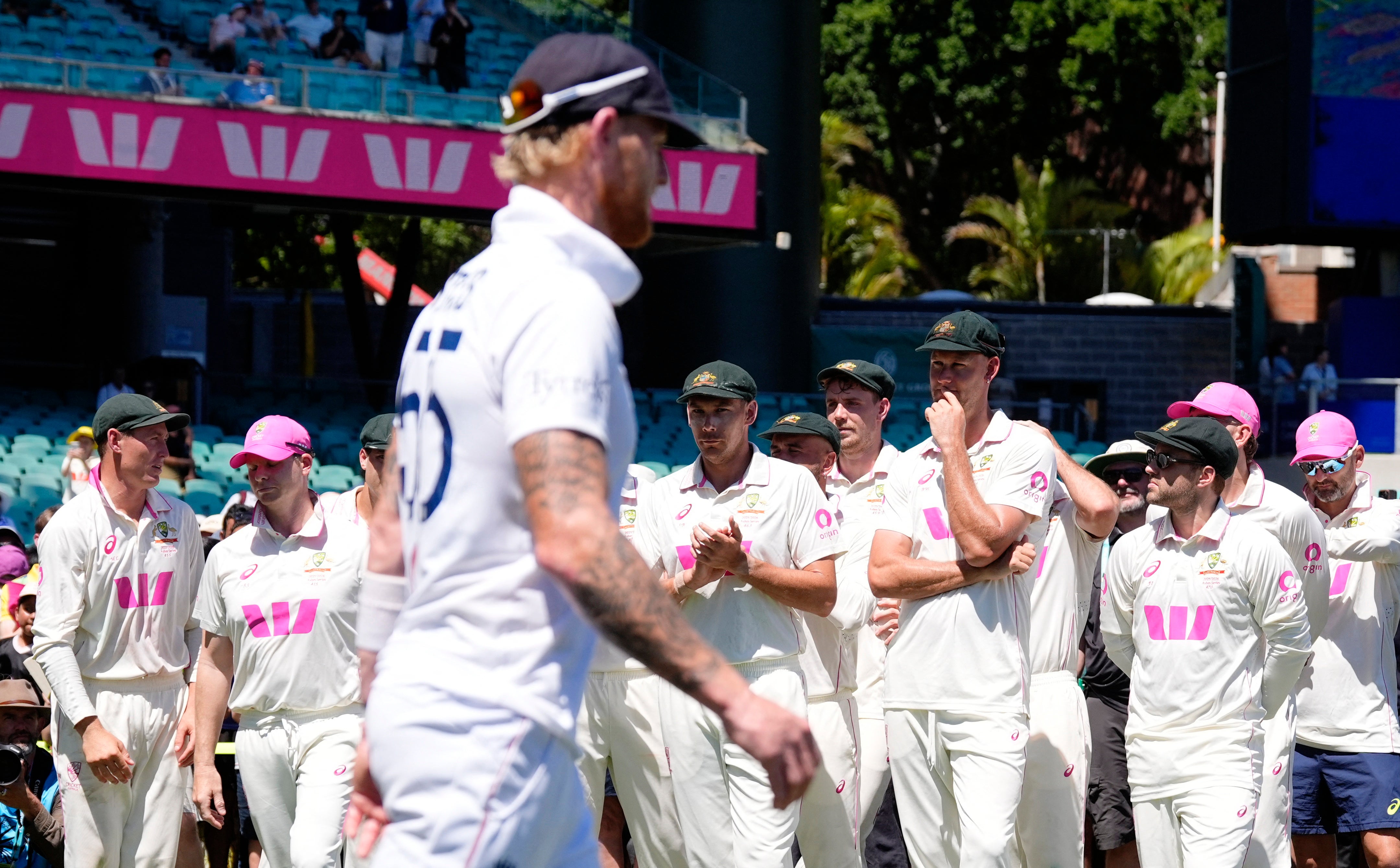 England's Ben Stokes after the match in Sydney as Australia players look on