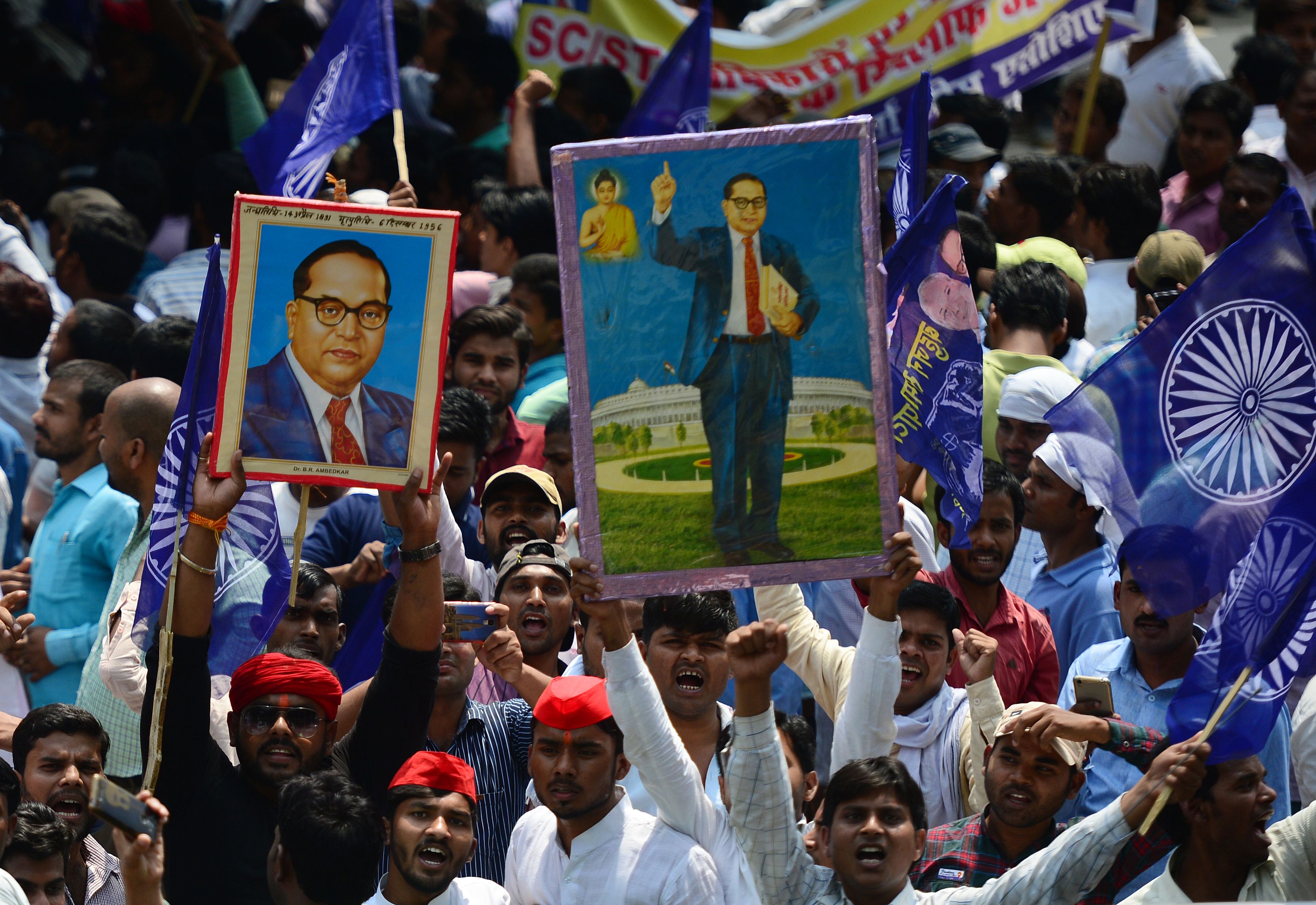 <p>File: Members of the Indian Dalit community stage a protest, with portraits of 20th century social reformer BR Ambedkar over caste discrimination in India</p>