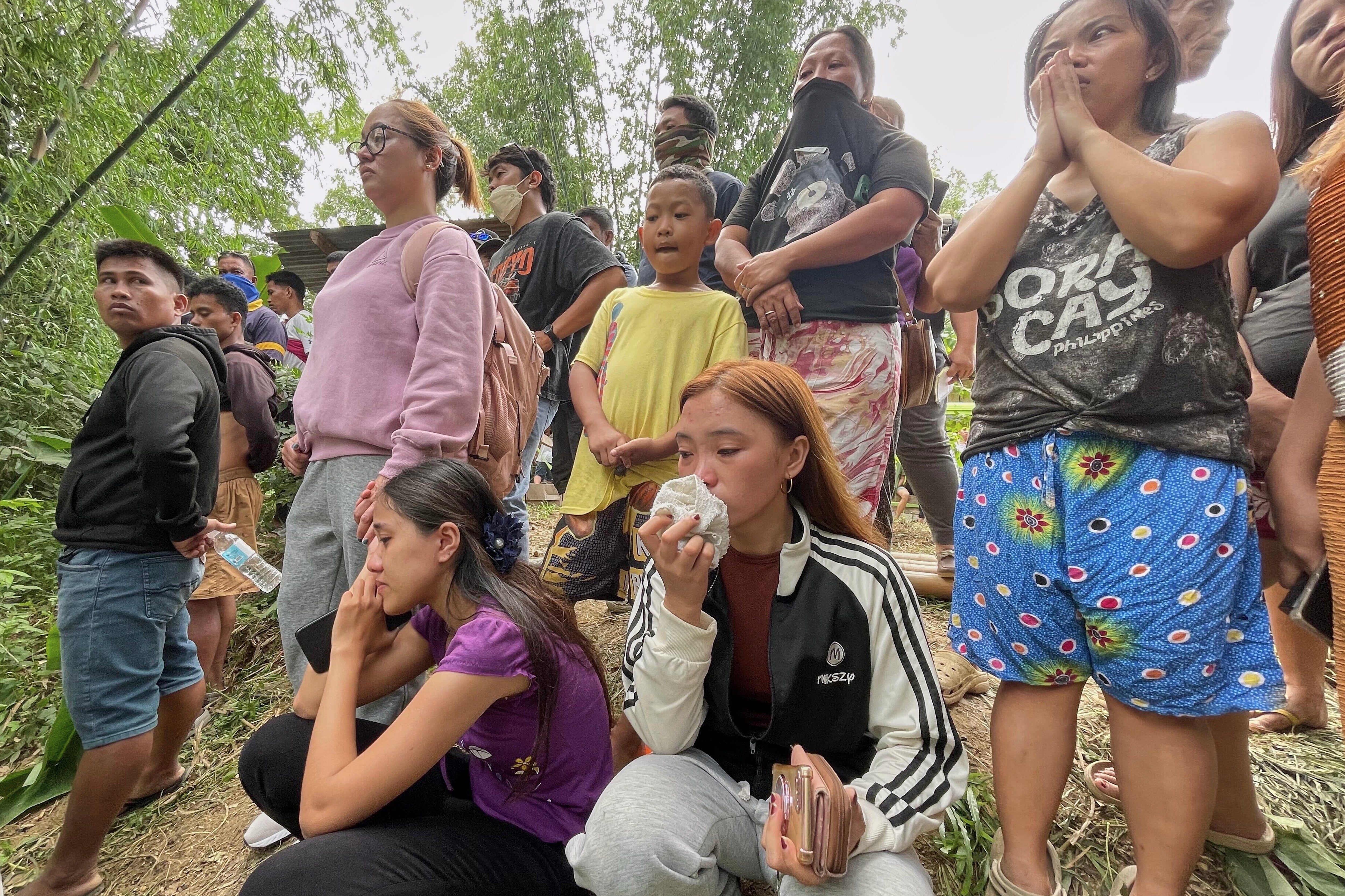 Relatives wait for news after a mound of garbage collapsed in Binaliw, Cebu city, on 9 January 2026