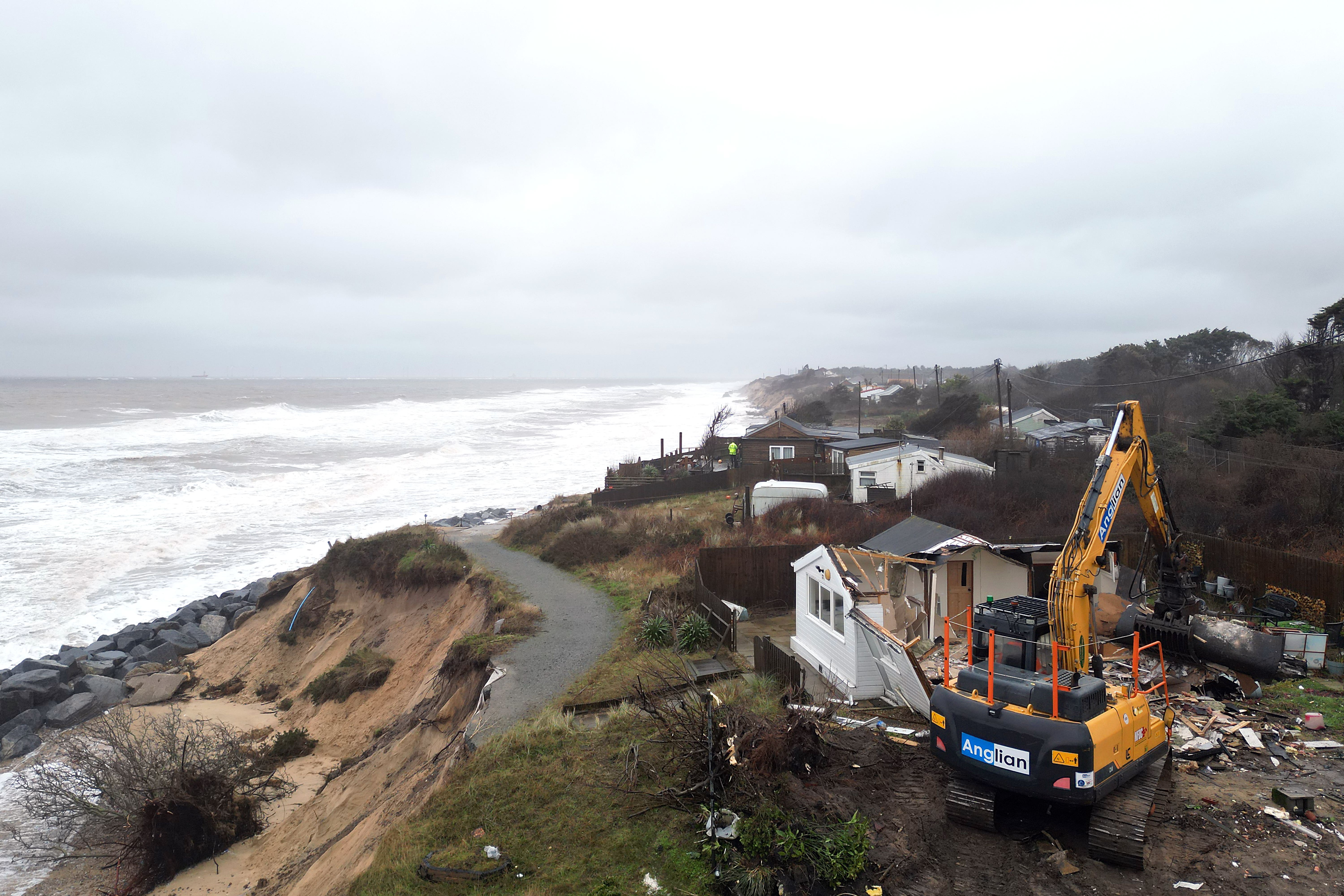 Properties being demolished close to the cliff edge at Hemsby in Norfolk which are at risk of collapse as high tides cut into sandy cliffs (Joe Giddens/ PA)
