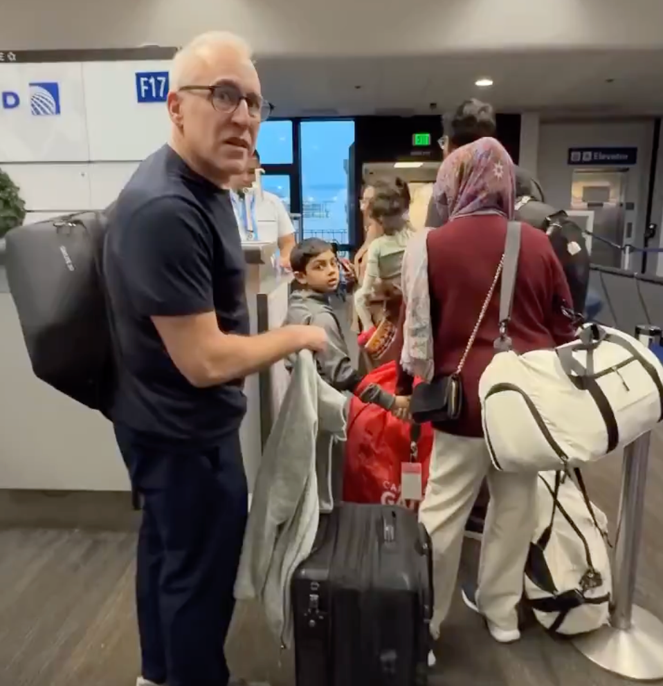 <p>An angry United Airlines passenger was confronted by others in the line over his demand to go before a family with young kids.</p>