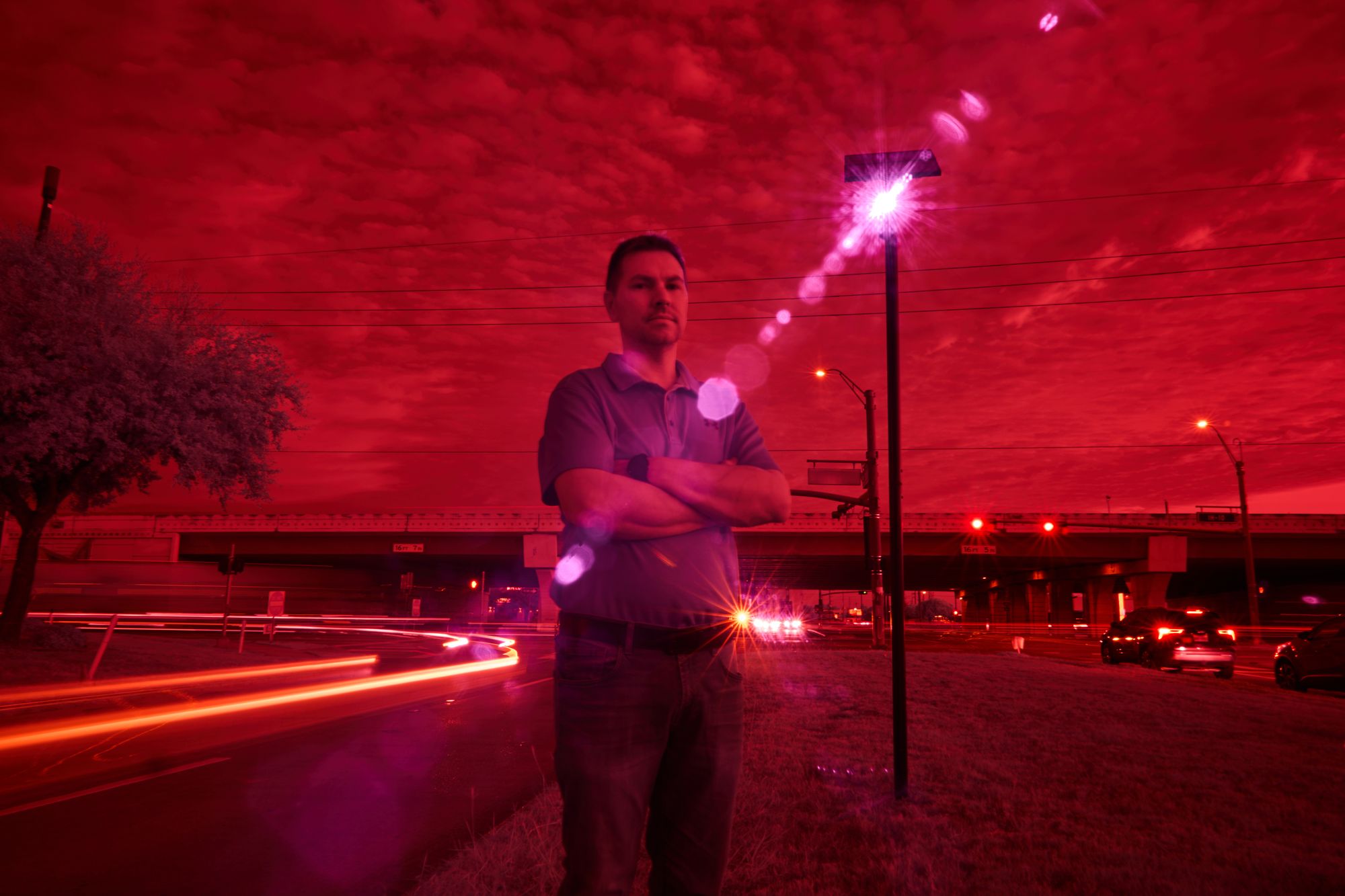 Houstonite Alek Schott, who is suing Texas authorities for violating his constitutional rights via indiscriminate surveillance, stands in the infrared beam of a Flock scanner in Houston, October 2025