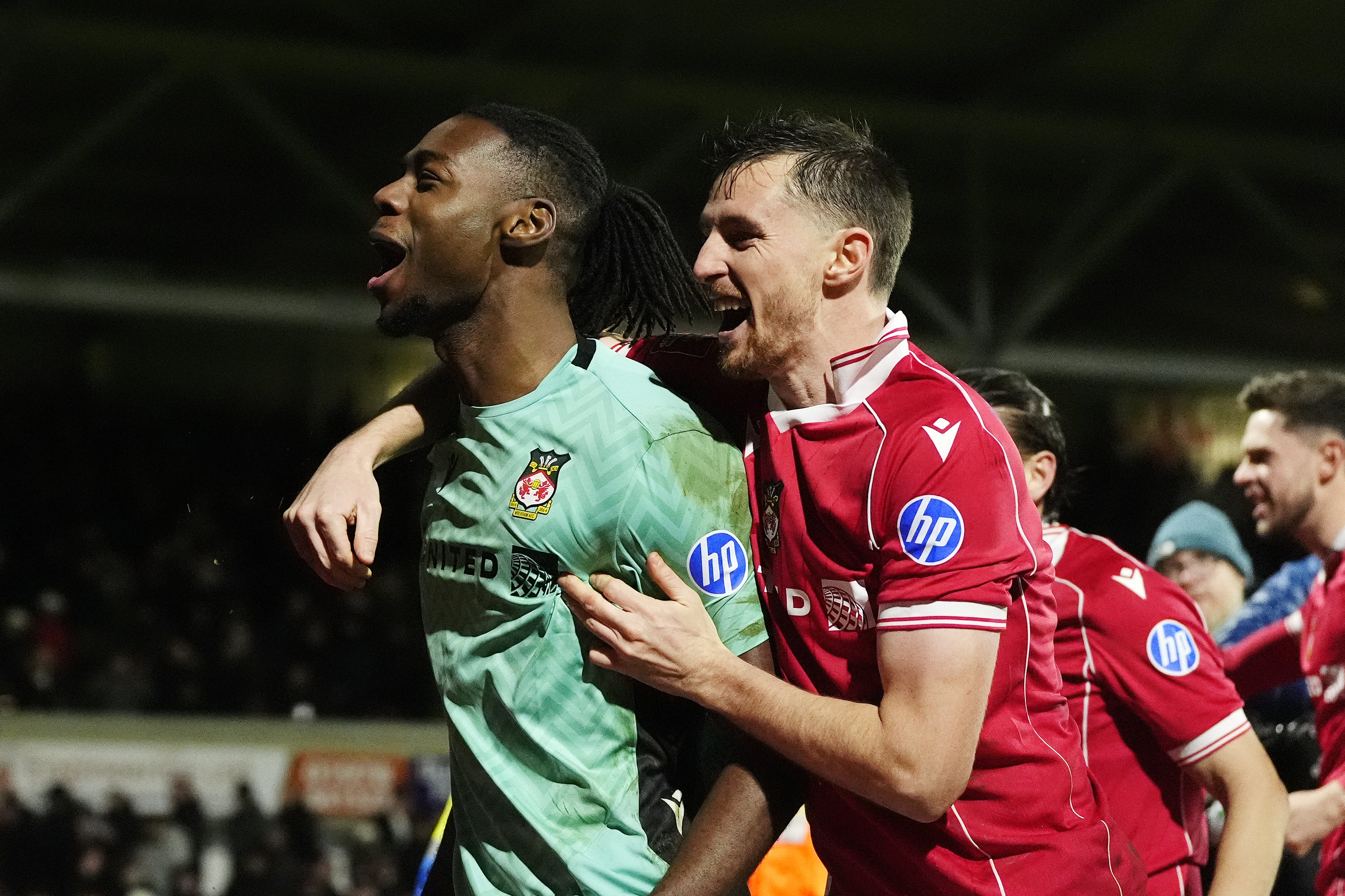 Wrexham goalkeeper Arthur Okonkwo (left) celebrates after sending his side through to the FA Cup fourth round on penaltes
