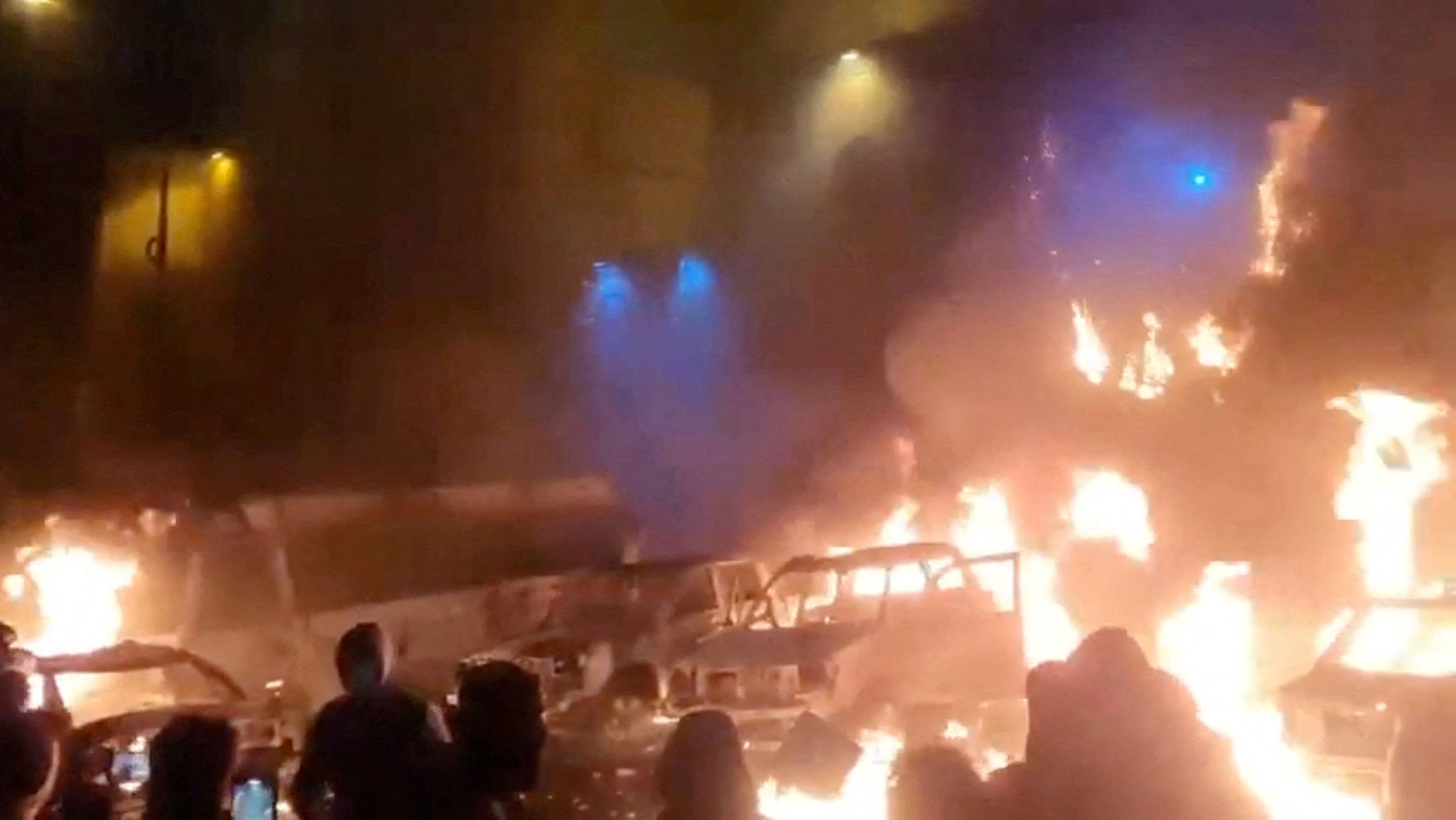 Buildings, shops, and cars have been set alight as thousands protest across Iran