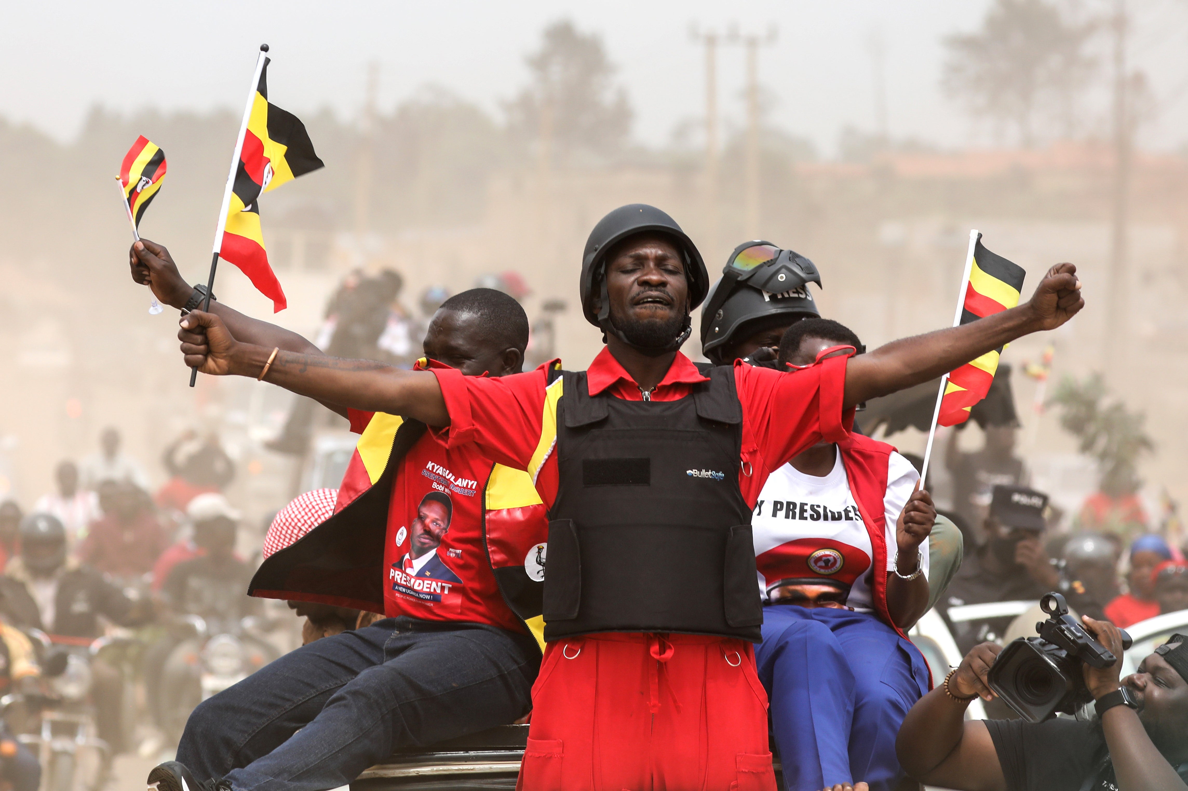 Uganda opposition presidential candidate Robert Kyagulanyi Ssentamu, who is known as Bobi Wine waves to supporters at an election campaign rally in Mukono, Uganda