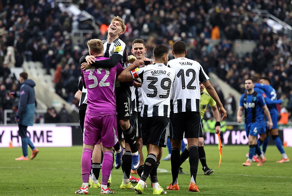 Newcastle players celebrate with Aaron Ramsdale after surviving a shoot-out against Bournemouth