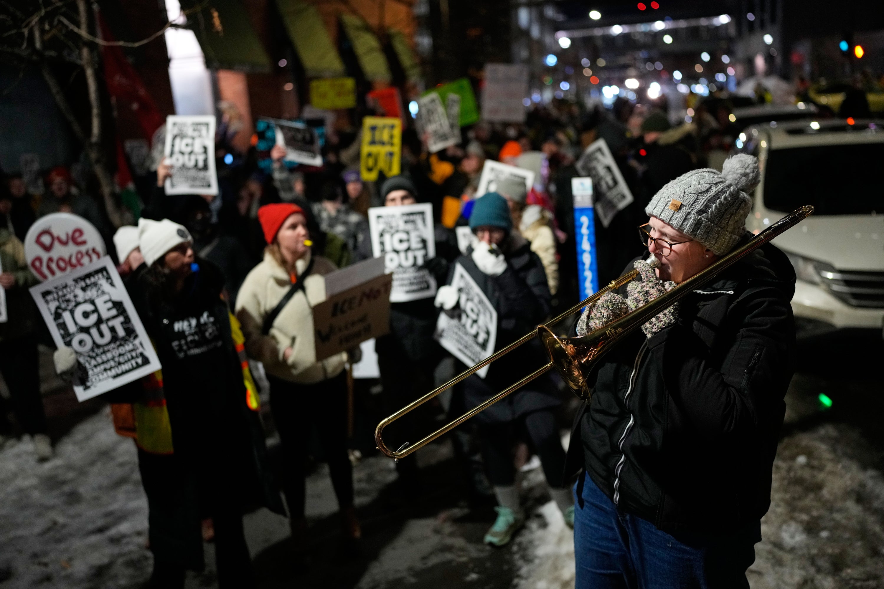 A demonstrator plays a trombone at an anti-ICE protest in downtown Minneapolis