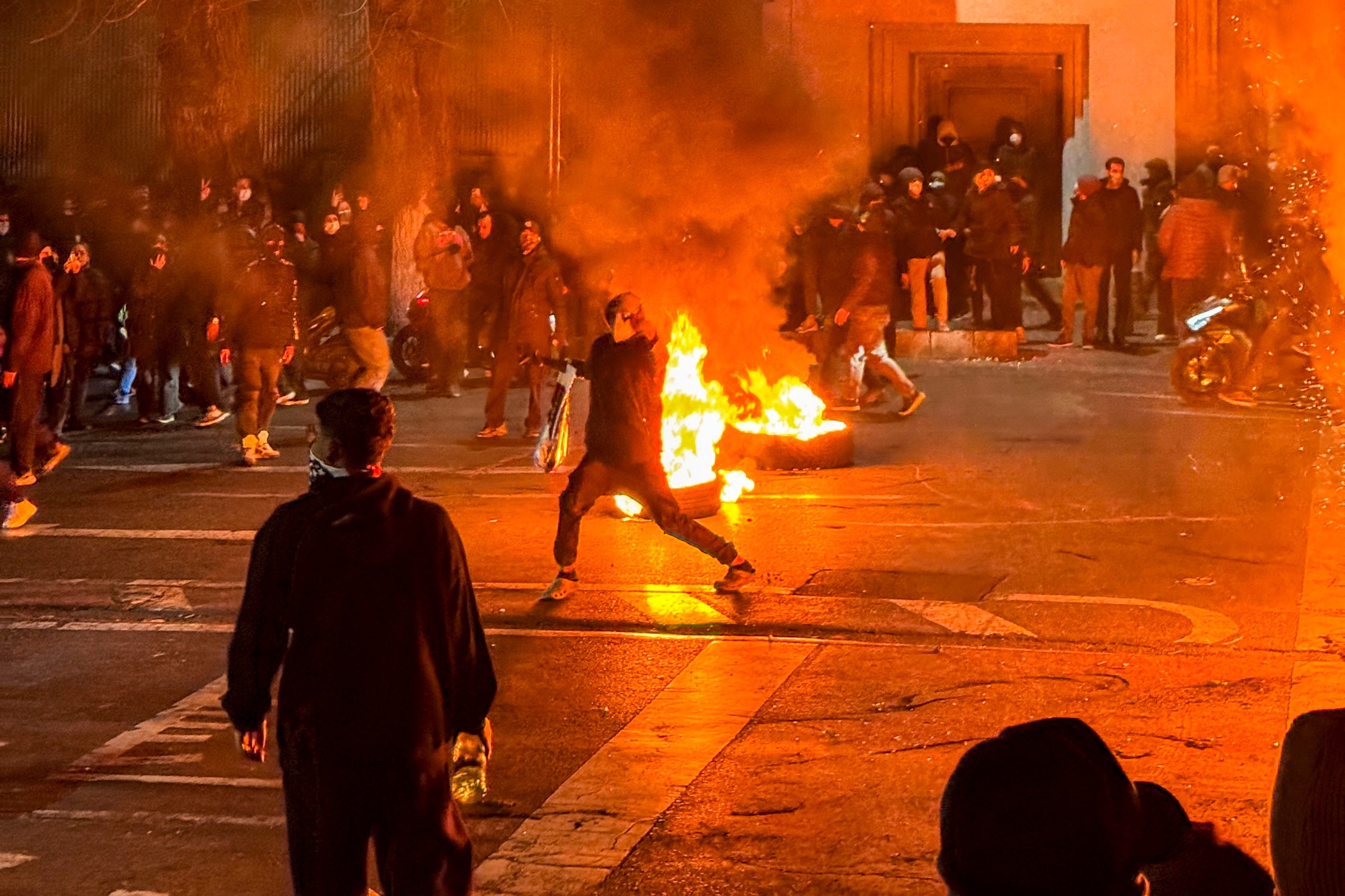 Iranians gather while blocking a street during a protest in Tehran, Iran on January 9, 2026. The nationwide protests started in Tehran's Grand Bazaar against the failing economic policies in late December, which spread to universities and other cities, and included economic slogans, to political and anti-government ones. (Photo by MAHSA / Middle East Images / AFP via Getty Images)