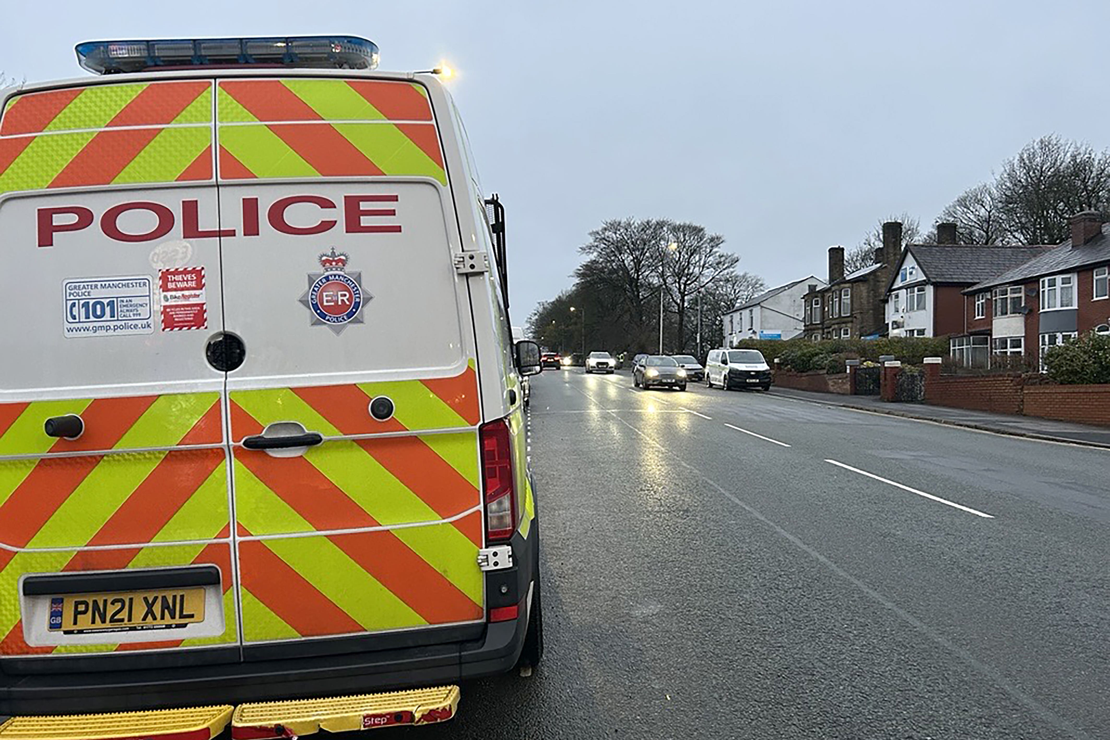 Police near the scene where a red Seat Leon collided with a Citroen C4 Picasso taxi on Wigan Road in Bolton (Madhuri Karia/PA)