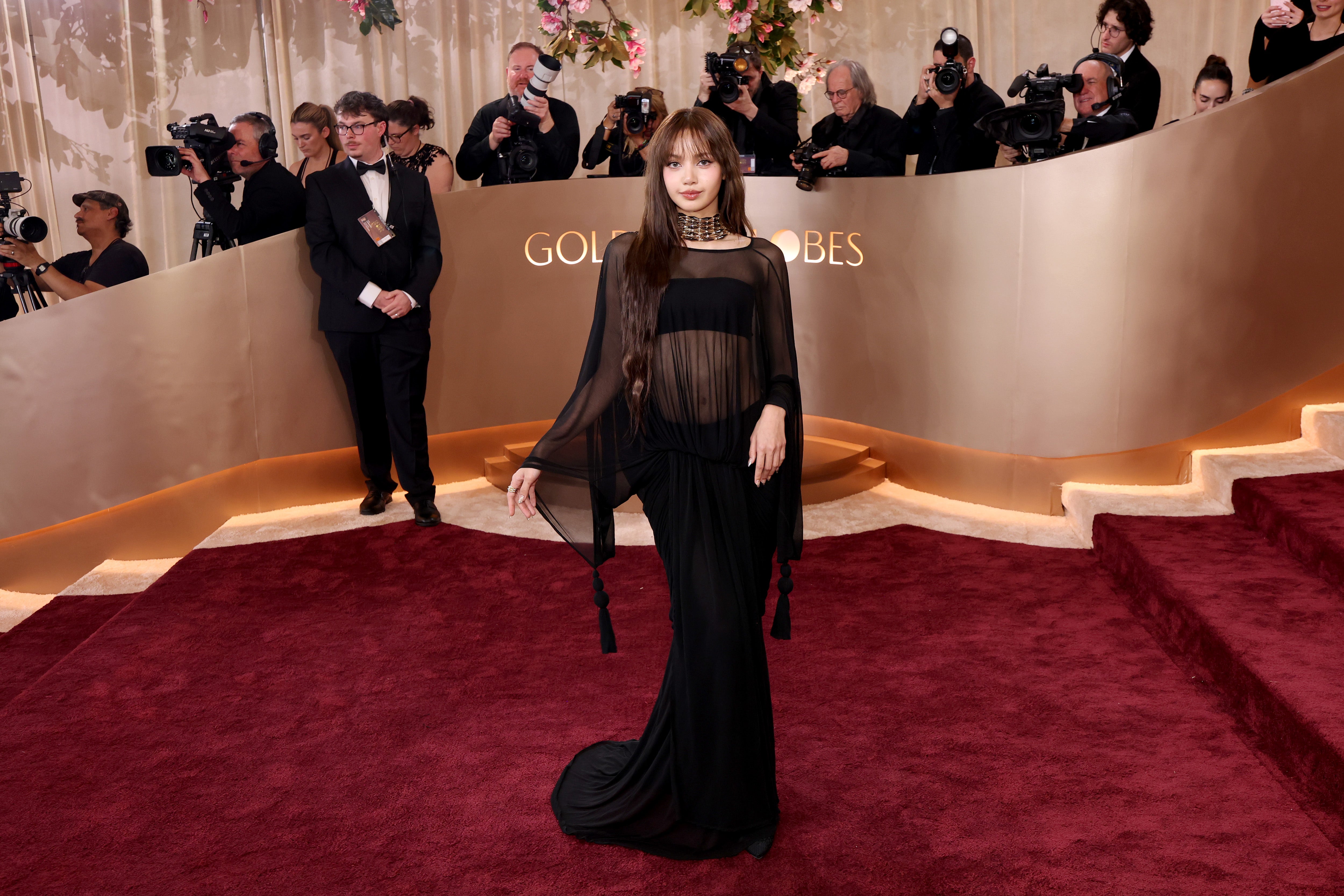 Blackpink member Lisa looked classy and chic in a trendy sheer black Jacquemus gown, with a matching skirt and bandeau underneath