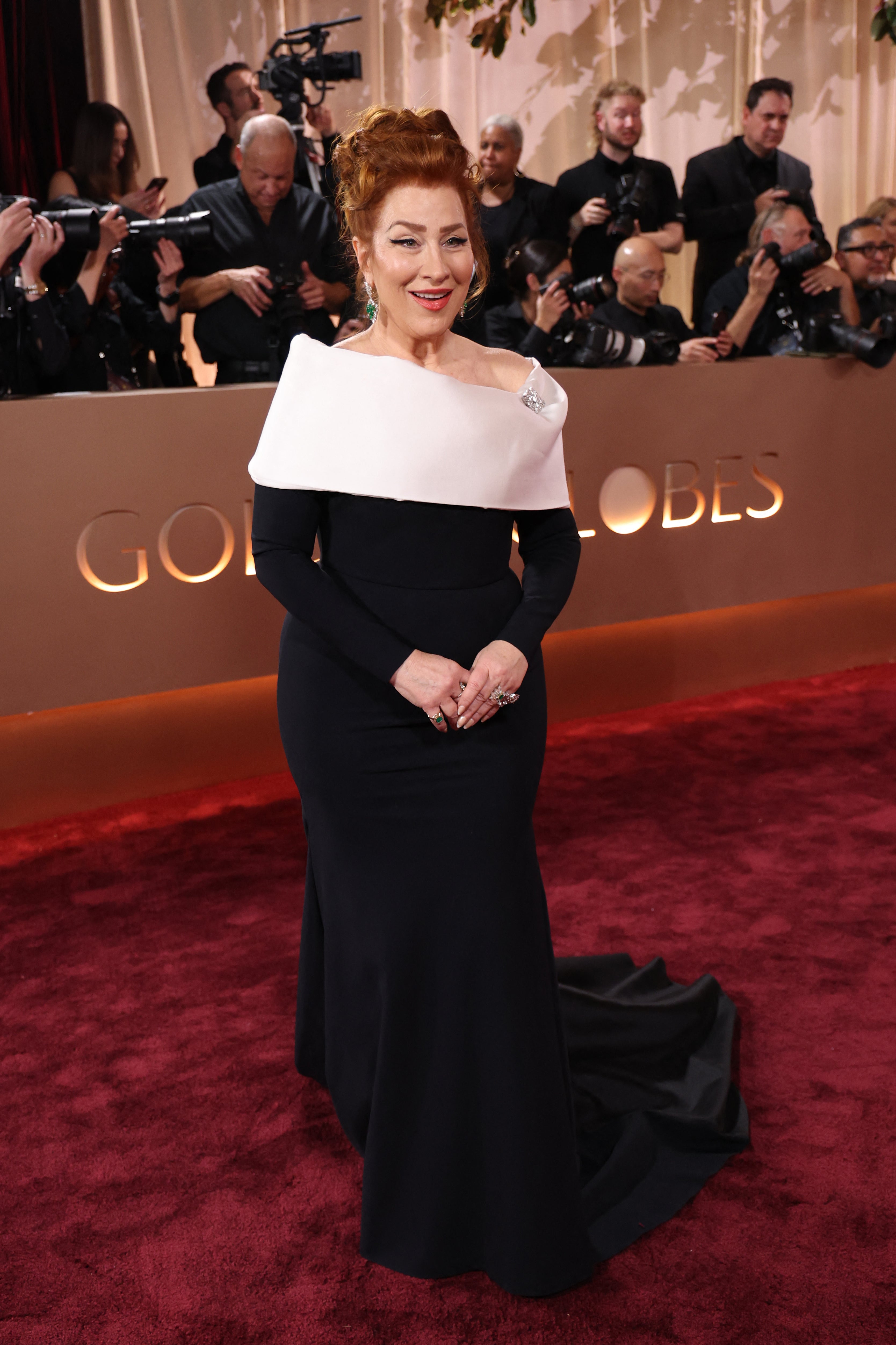 ‘Abbott Elementary’ star Lisa Ann Walter wore a classic black and white, off-the-shoulder gown by Greta Constantine, featuring a silver brooch