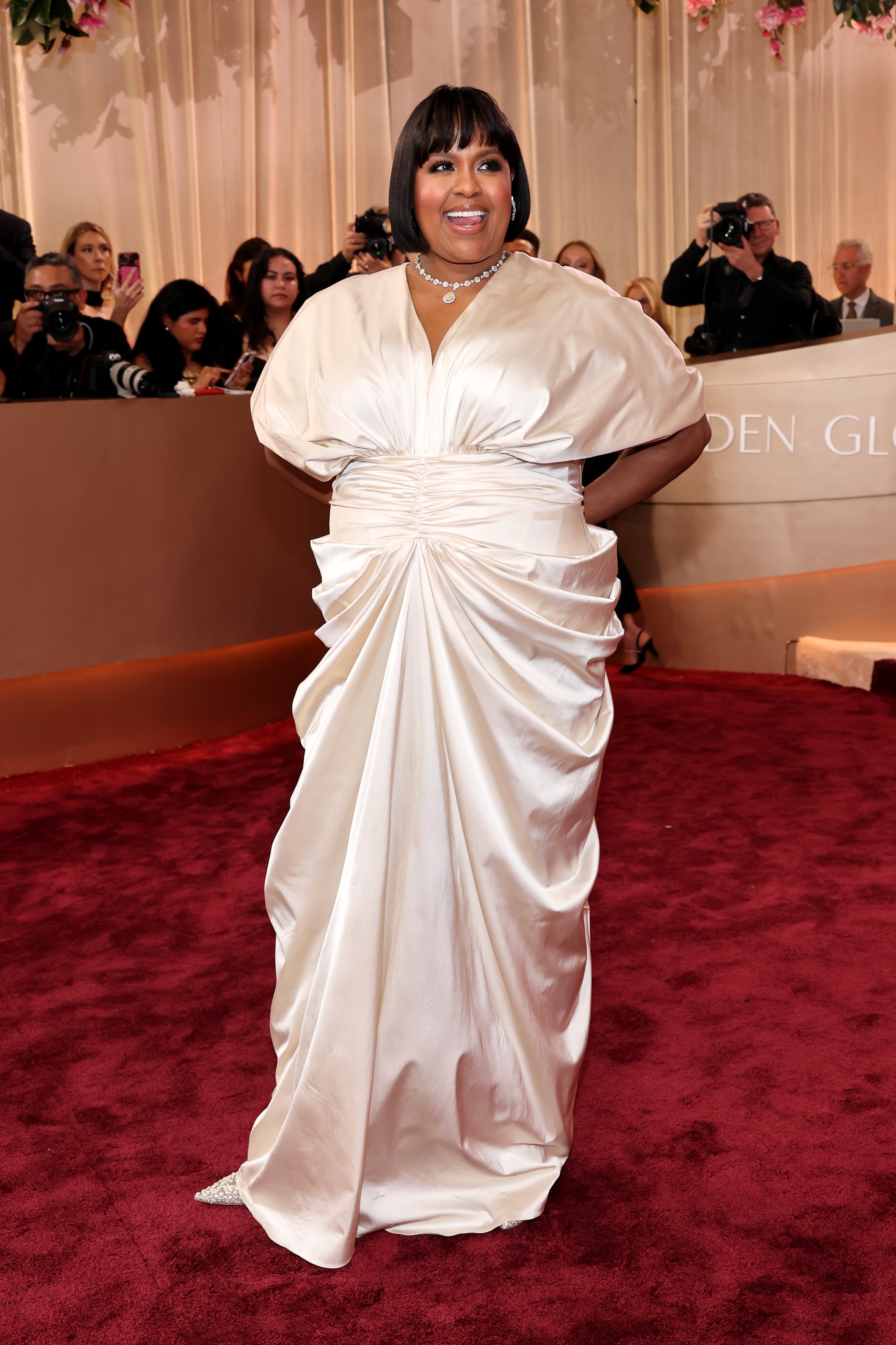 Natasha Rothwell wore a white ruched V-neck gown that appeared to be wrinkled at the bottom