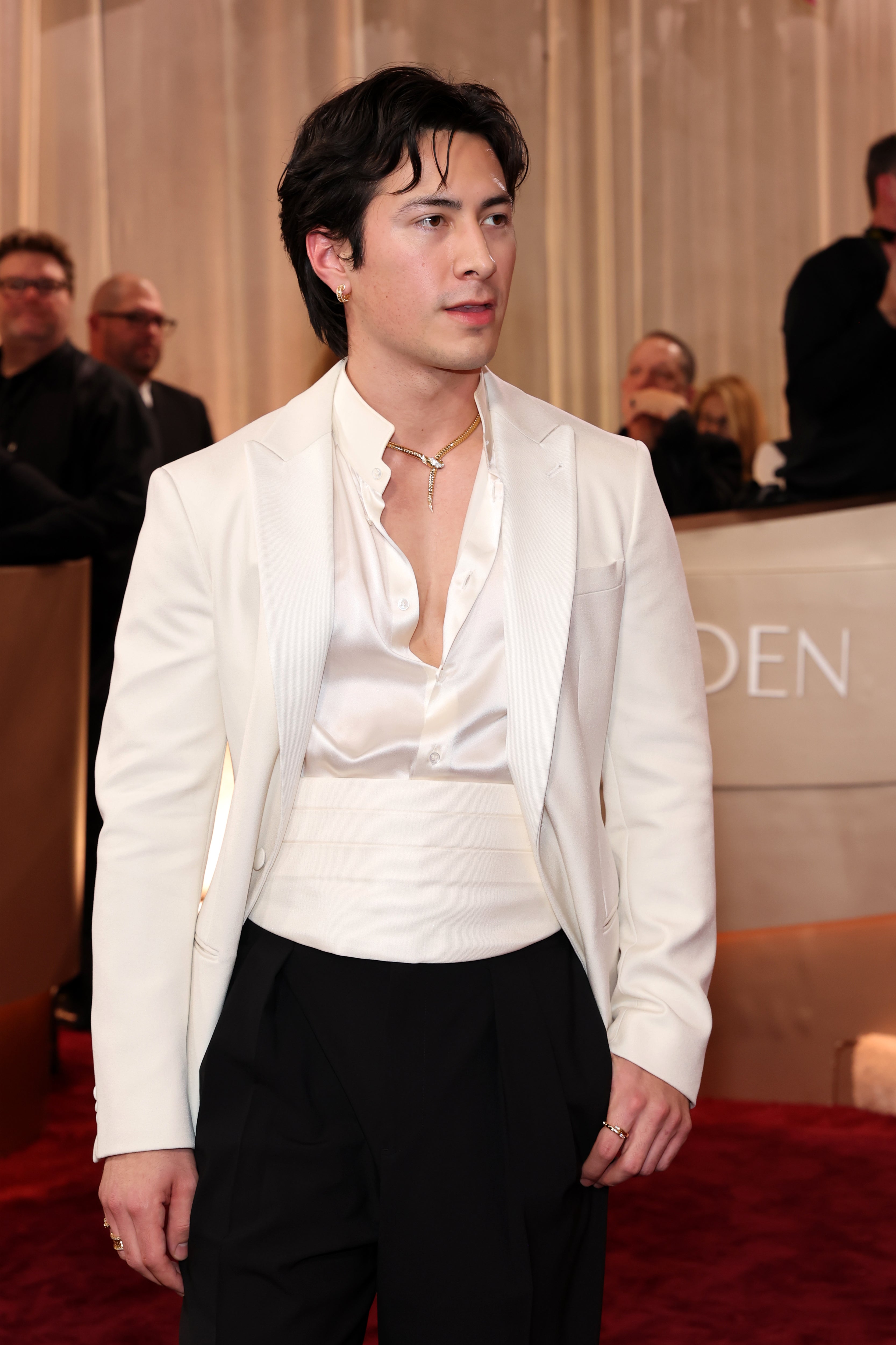 He paired the look with small silver hoop earrings and a gold necklace