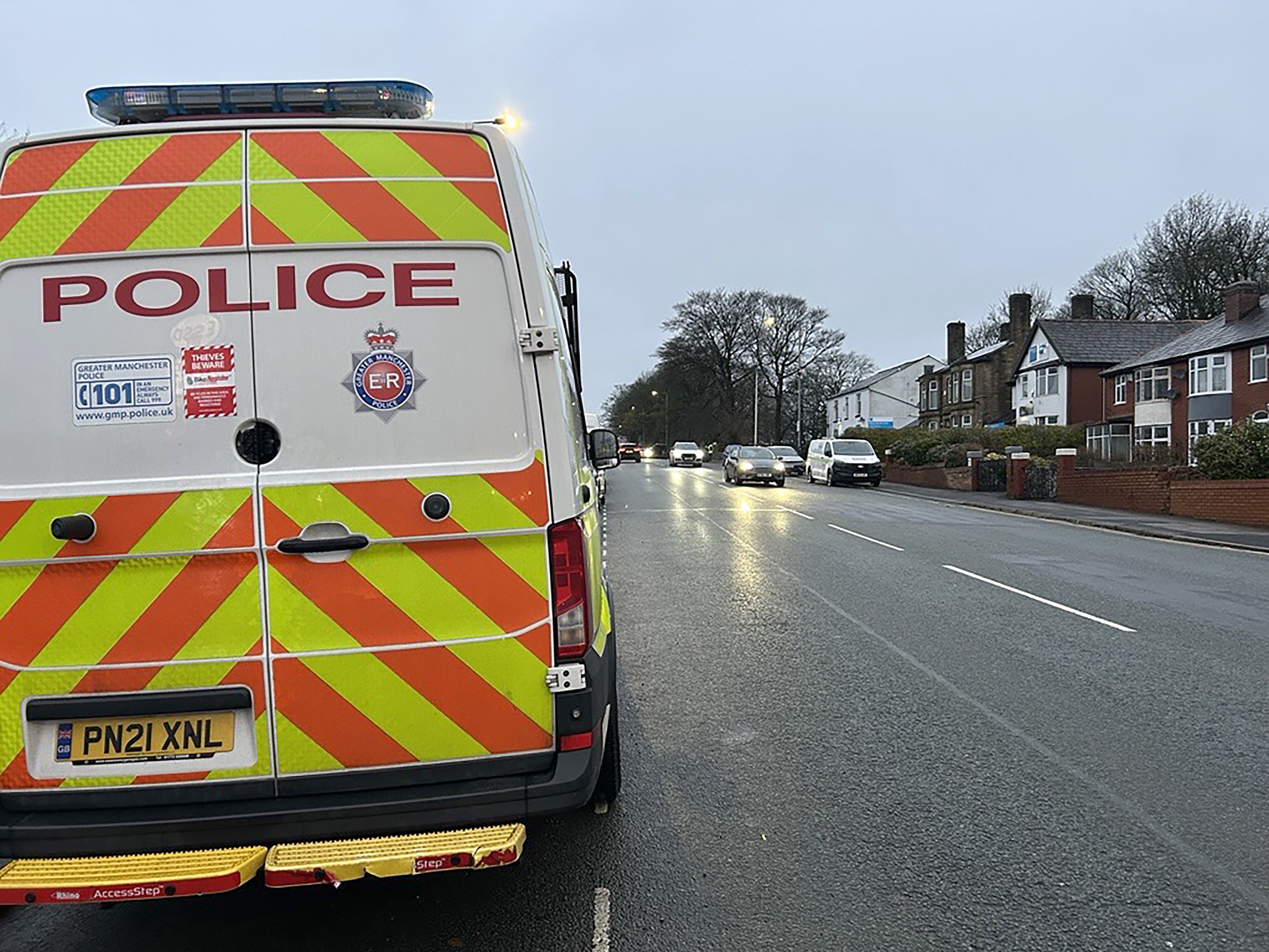 Police near the scene where a Seat Leon collided with a Citroen C4 Picasso taxi on Wigan Road in Bolton