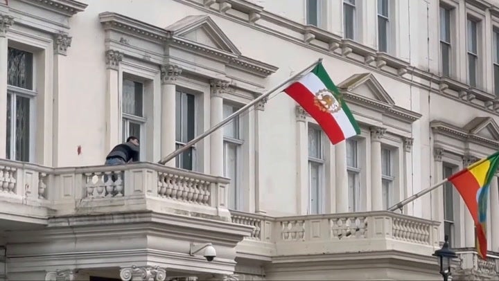 <p>Protester tears down flag at Iranian Embassy</p>