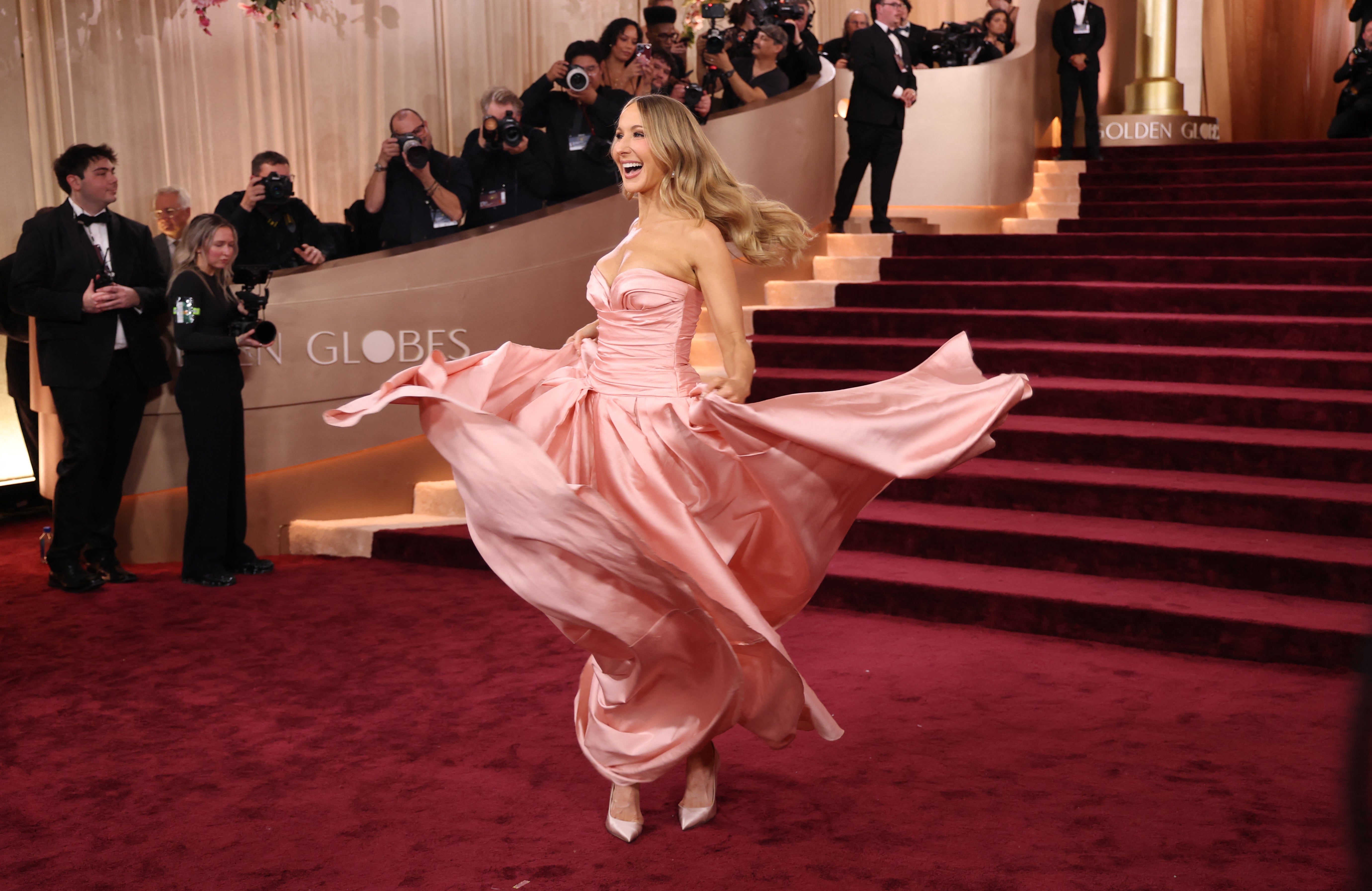The comedian also took a moment to twirl around in her dress, showing off her matching pink shoes