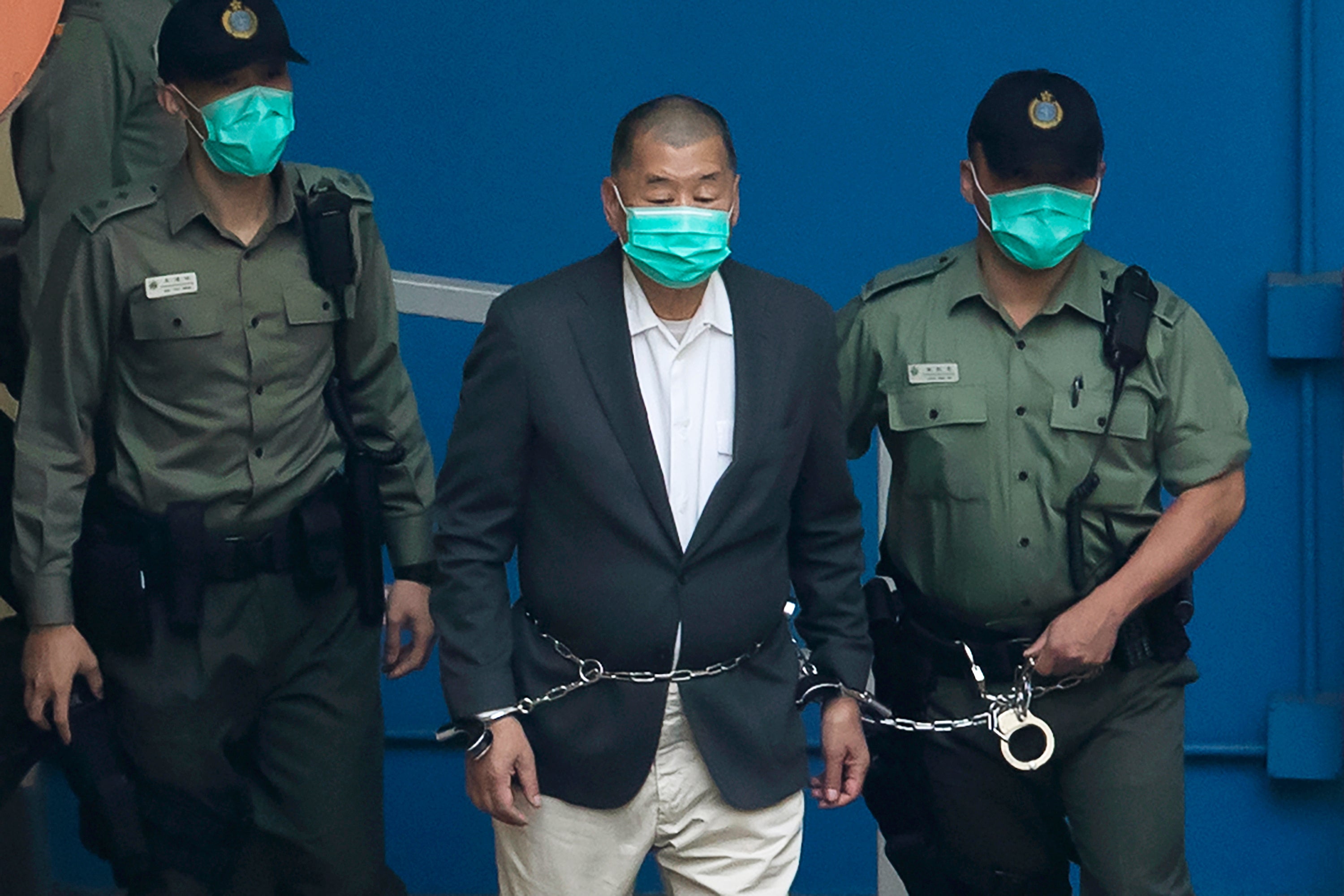Jimmy Lai is escorted to a prison van before appearing in a Hong Kong court on 12 December 2020