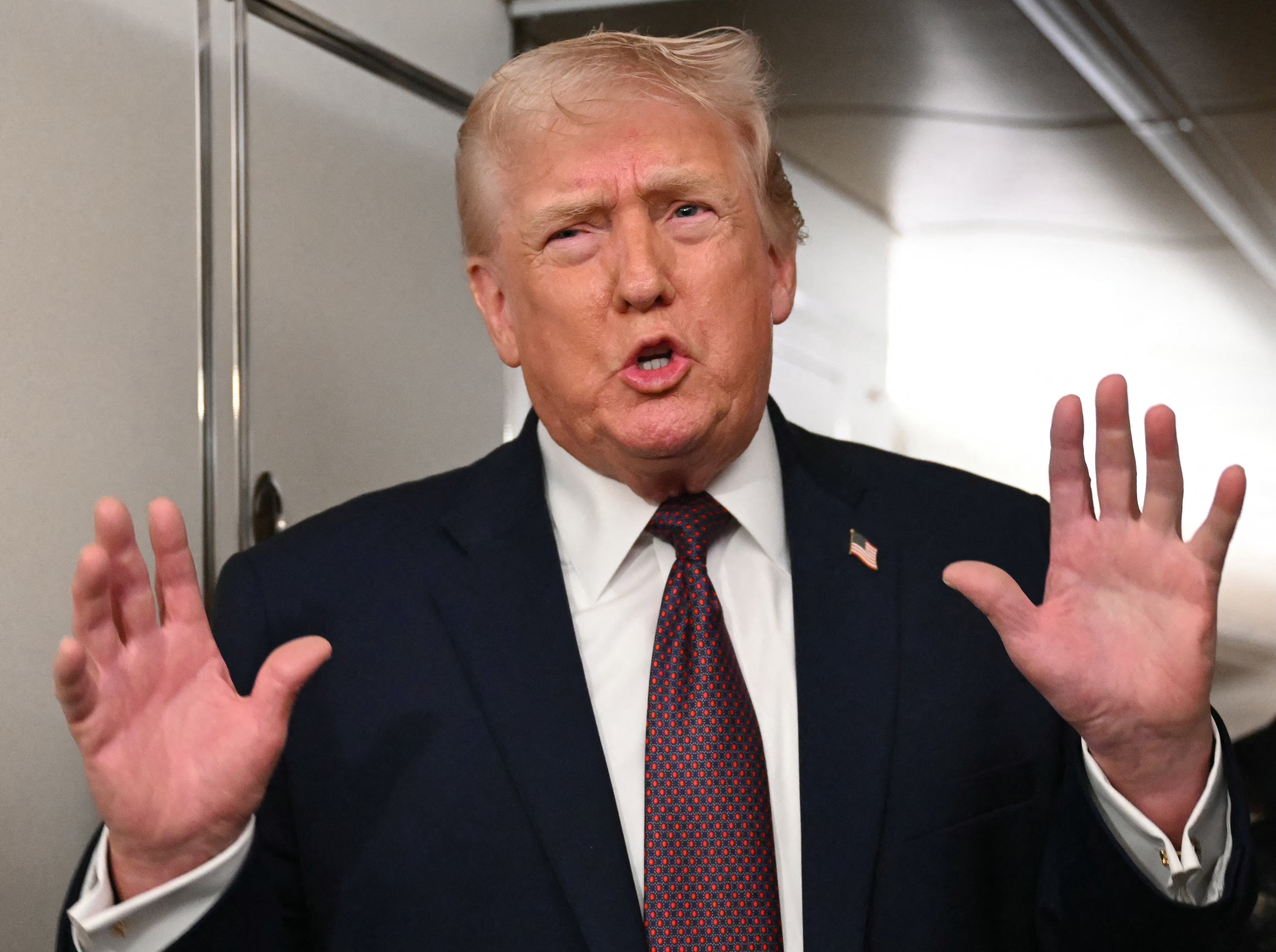 <p>U.S. President Donald Trump speaks to the press aboard Air Force One on Sunday January 11, 2026</p>