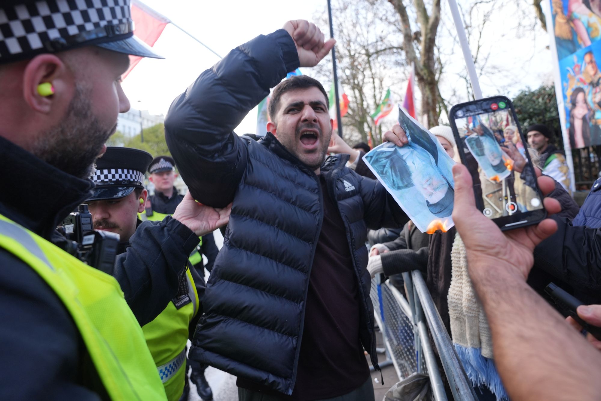 <p>Metropolitan Police arrested 14 people on suspicion of offences including violent disorder and trespass after protests outside Iran’s London embassy turned violent. </p>