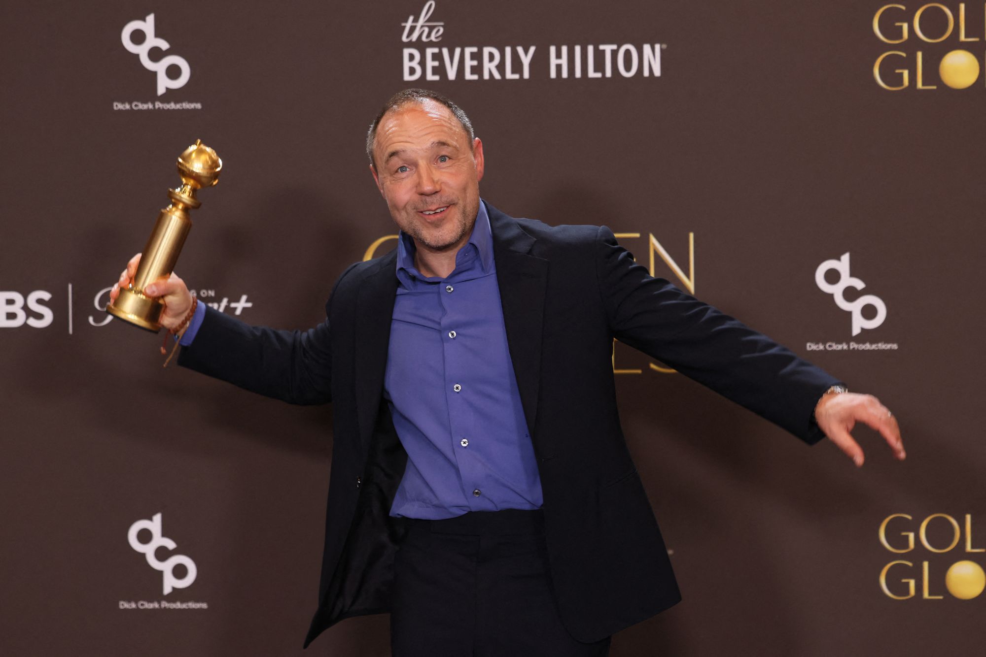 <p>British actor Stephen Graham poses in the press room with his golden globe award</p>