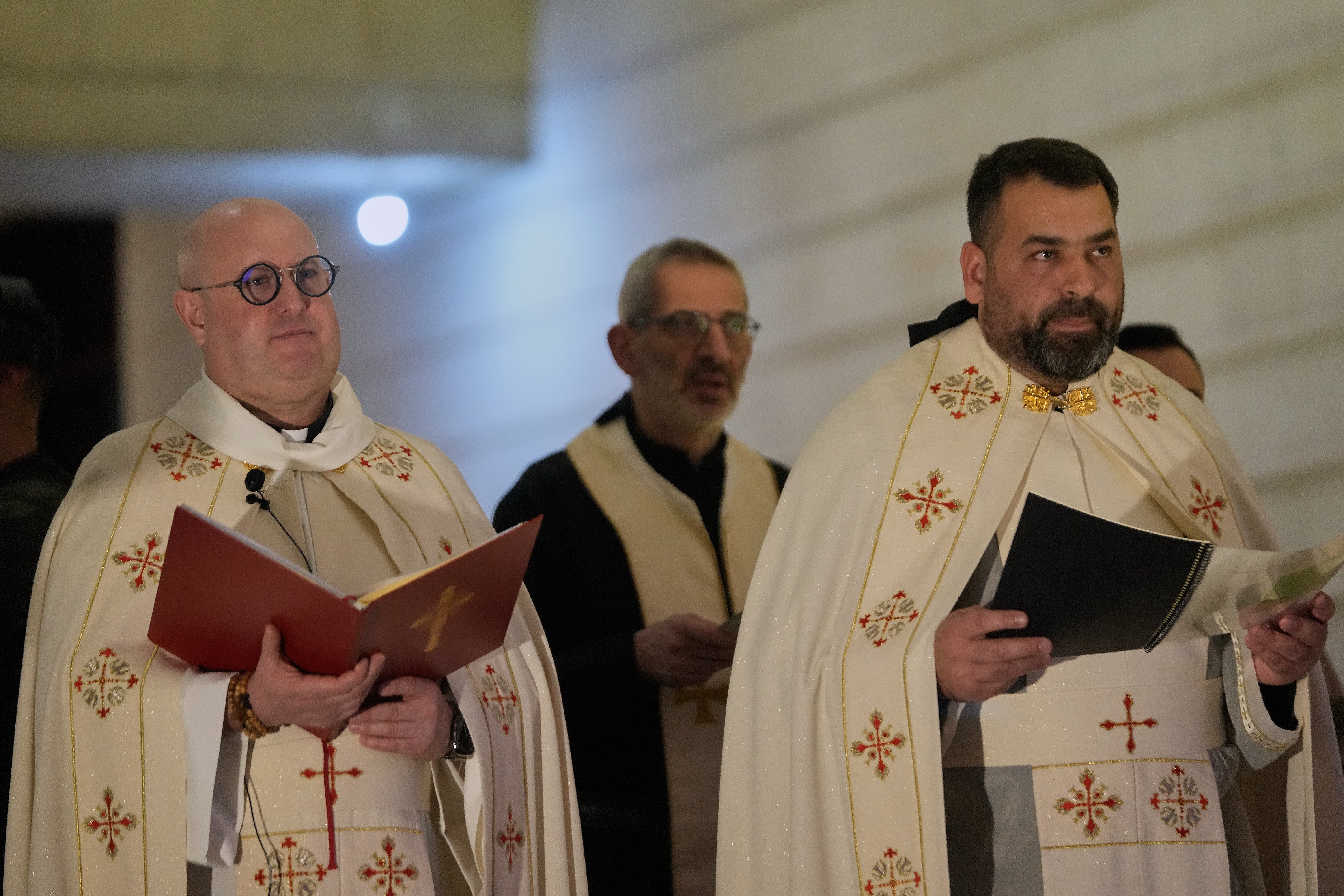 Portuguese Catholic priest and deejay Guilherme Peixoto, left, leads a Mass service ahead of his concert at the Holy Spirit University of Kaslik, Lebanon, Saturday, Jan. 10, 2026, after a Lebanese court rejected a petition to ban his concert. (AP Photo/Hussein Malla)