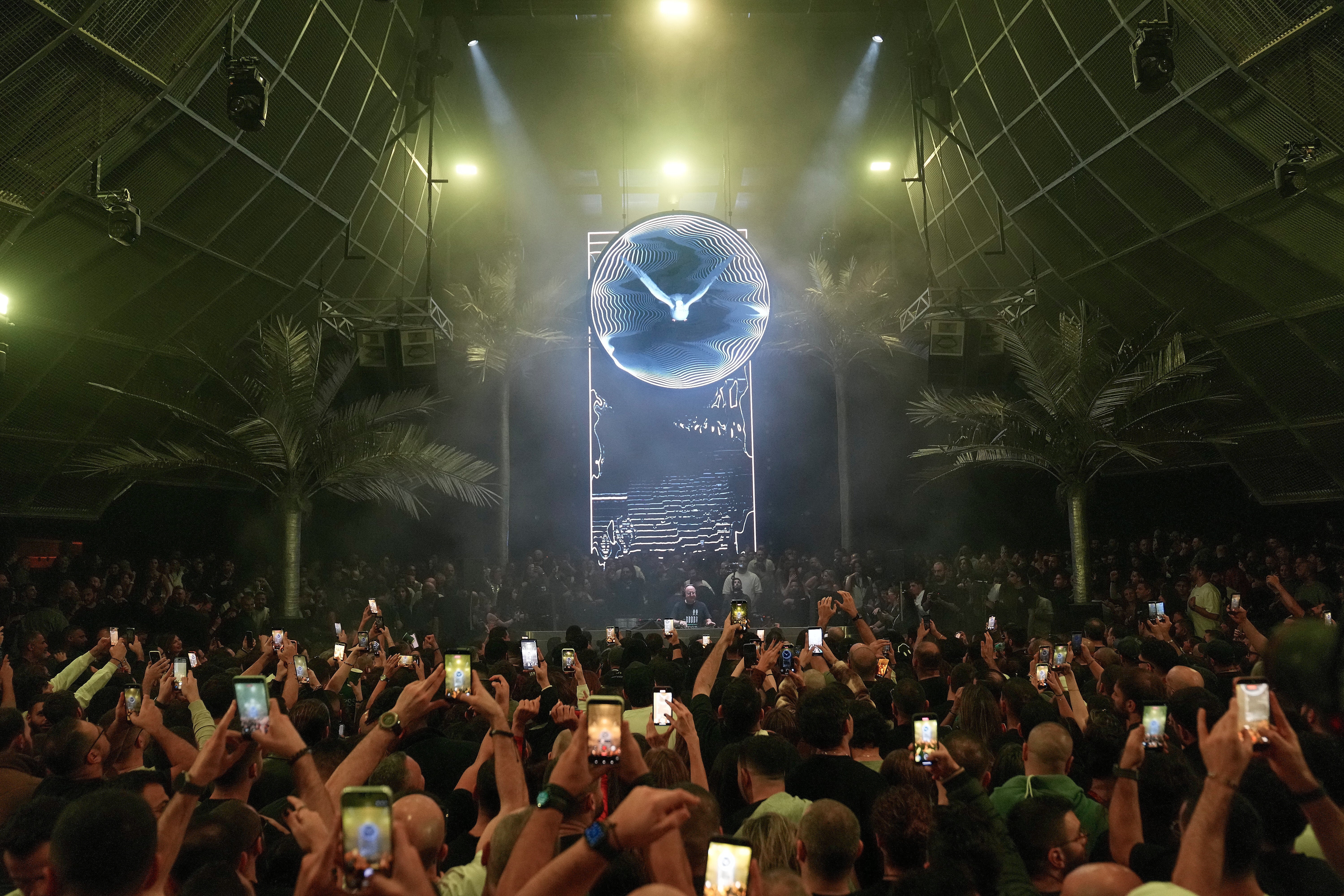 Portuguese Catholic priest and deejay Guilherme Peixoto, centre background, performs during a concert in Beirut, Lebanon, Sunday, Jan. 11, 2026, after a Lebanese court rejected a request by a group of Christian religious figures, who filed a petition seeking a ban to the concert saying it violates the church's teachings. (AP Photo/Hussein Malla)