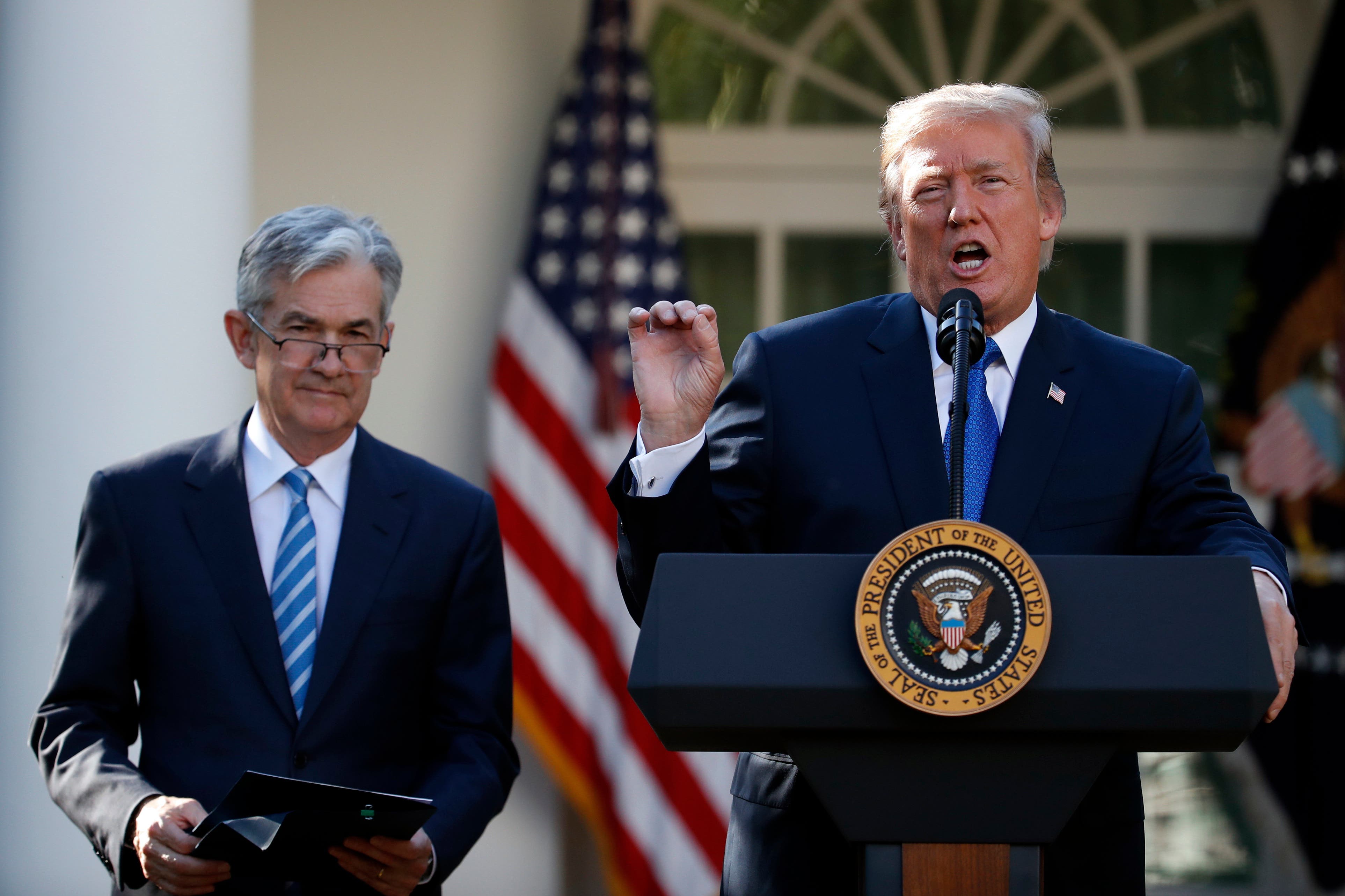 Federal Reserve Chairman Jerome Powell, left, has faced pressure from President Donald Trump’s administration to lower rates