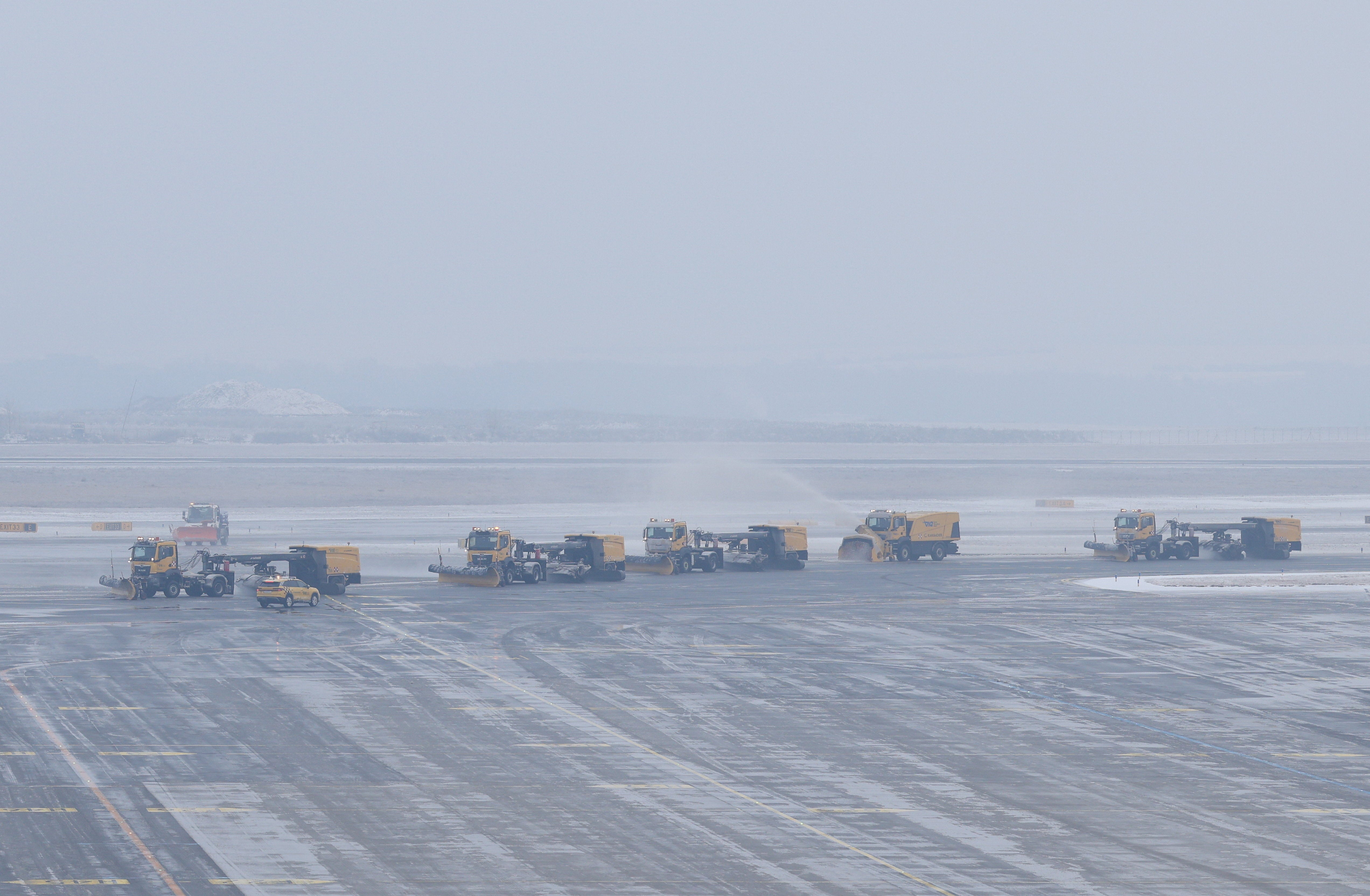 Snow ploughs on the tarmac at Vienna International Airport