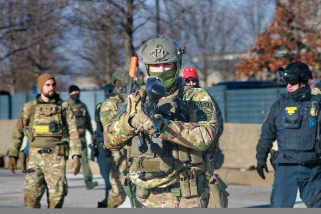 <p>Federal agents advance during an enforcement operation outside of an ICE facility in Minneapolis on January 11, 2026</p>