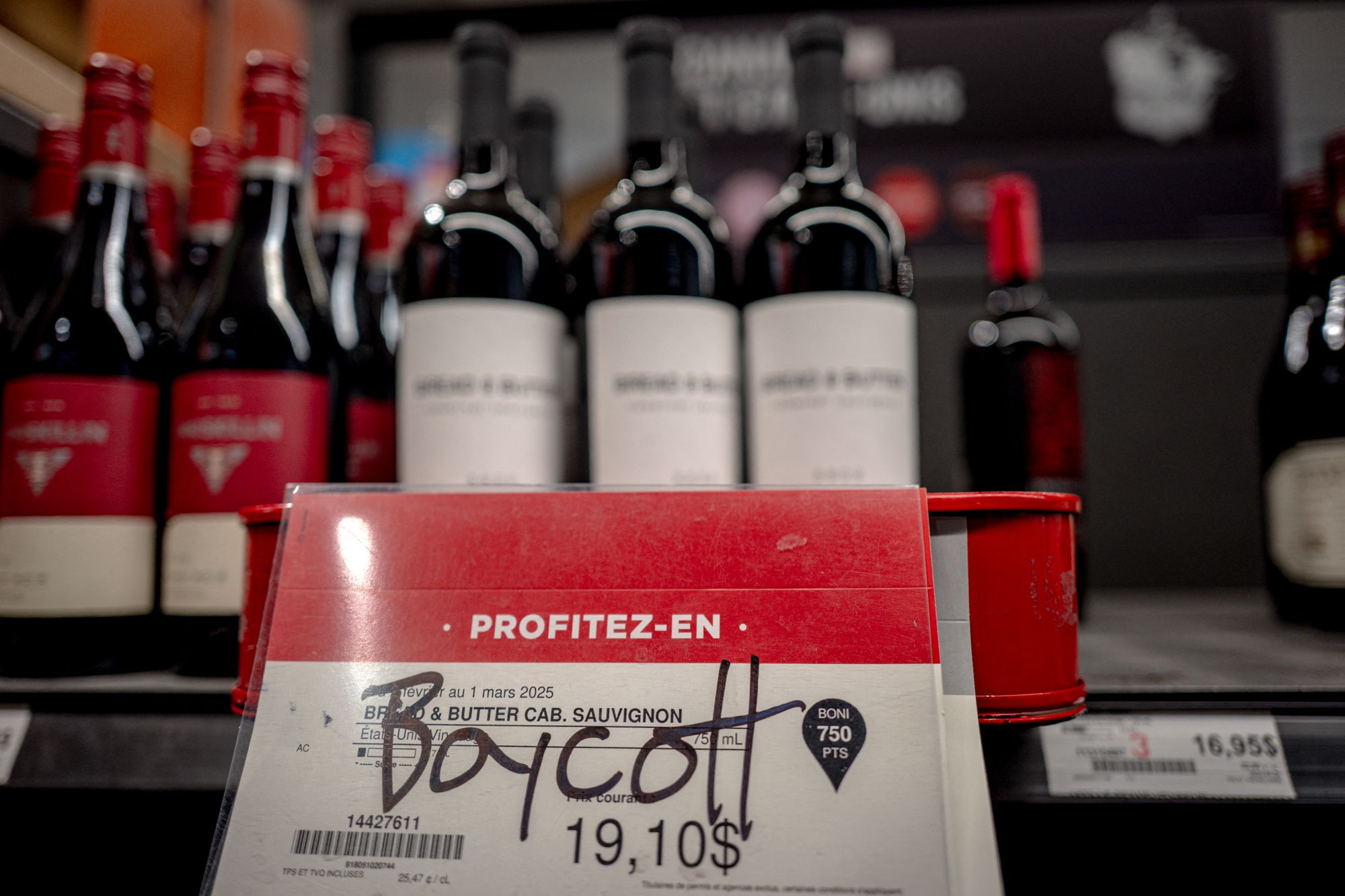 Grafitti calling for a boycott on American wine at a liquor store in Montreal, Canada
