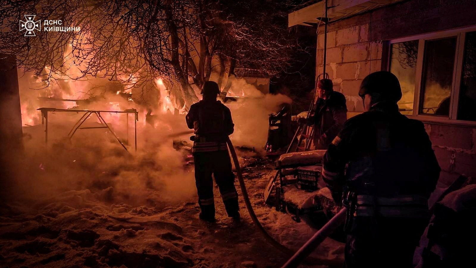 Firefighters work at the site of a residential household damaged during Russian drone and missile strikes, amid Russia's attack on Ukraine, in Kyiv region, Ukraine, January 13, 2026