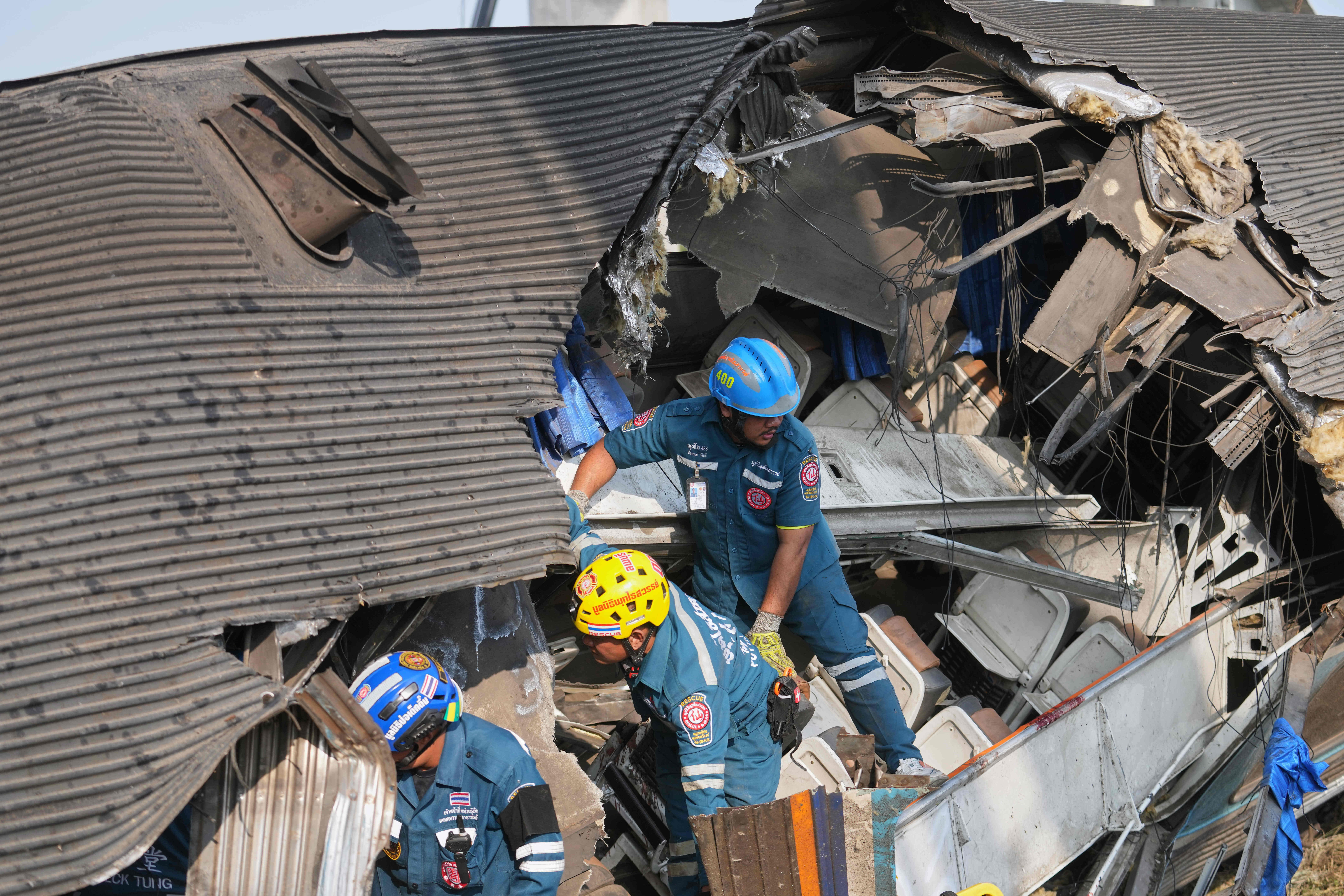 Rescuers work amidst the wreckage.