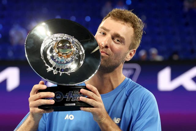 <p>Australia's Jordan Smith celebrates with the trophy after defeating Taiwan's Joanna Garland</p>