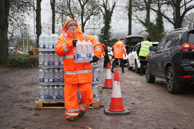 South East Water staff hand out bottled water at a water station in Maidstone (Gareth Fuller/PA)