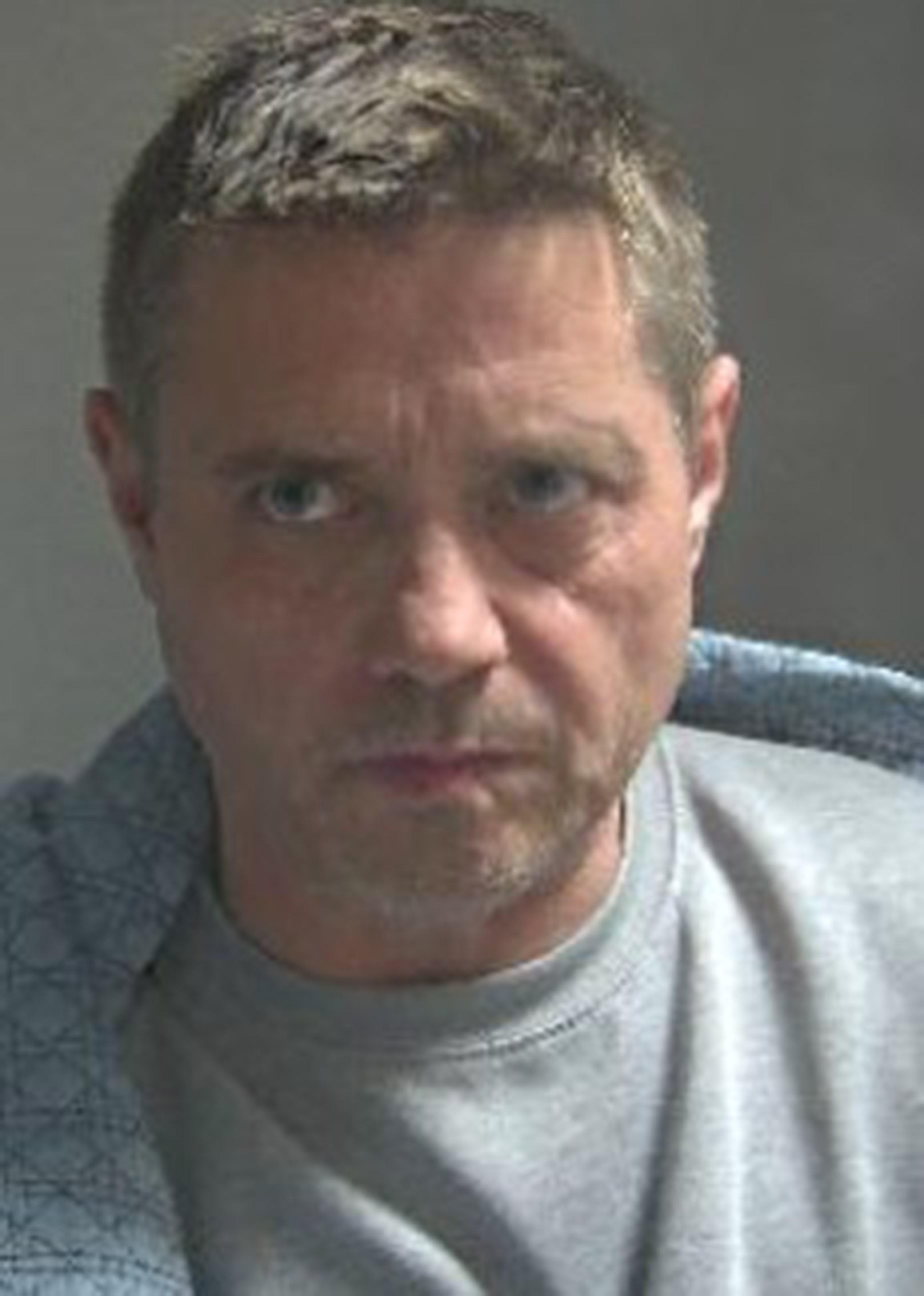 A mugshot issued by Hertfordshire Police of John Alford, real name John Shannon