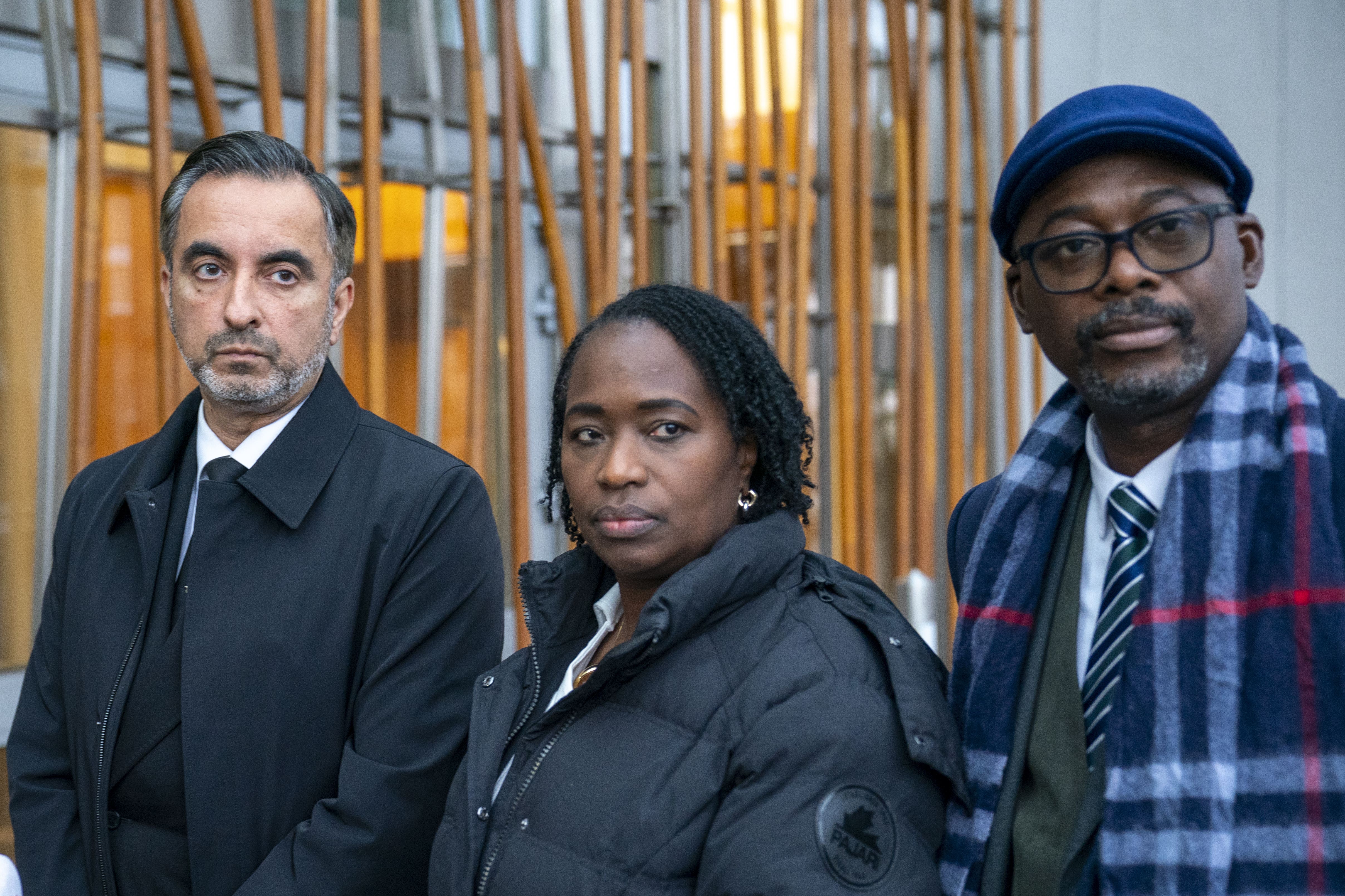 Lawyer Aamer Anwar, left, with Shehu Bayoh’s sister Kadi Johnson and her husband Ade Johnson (Jane Barlow/PA)