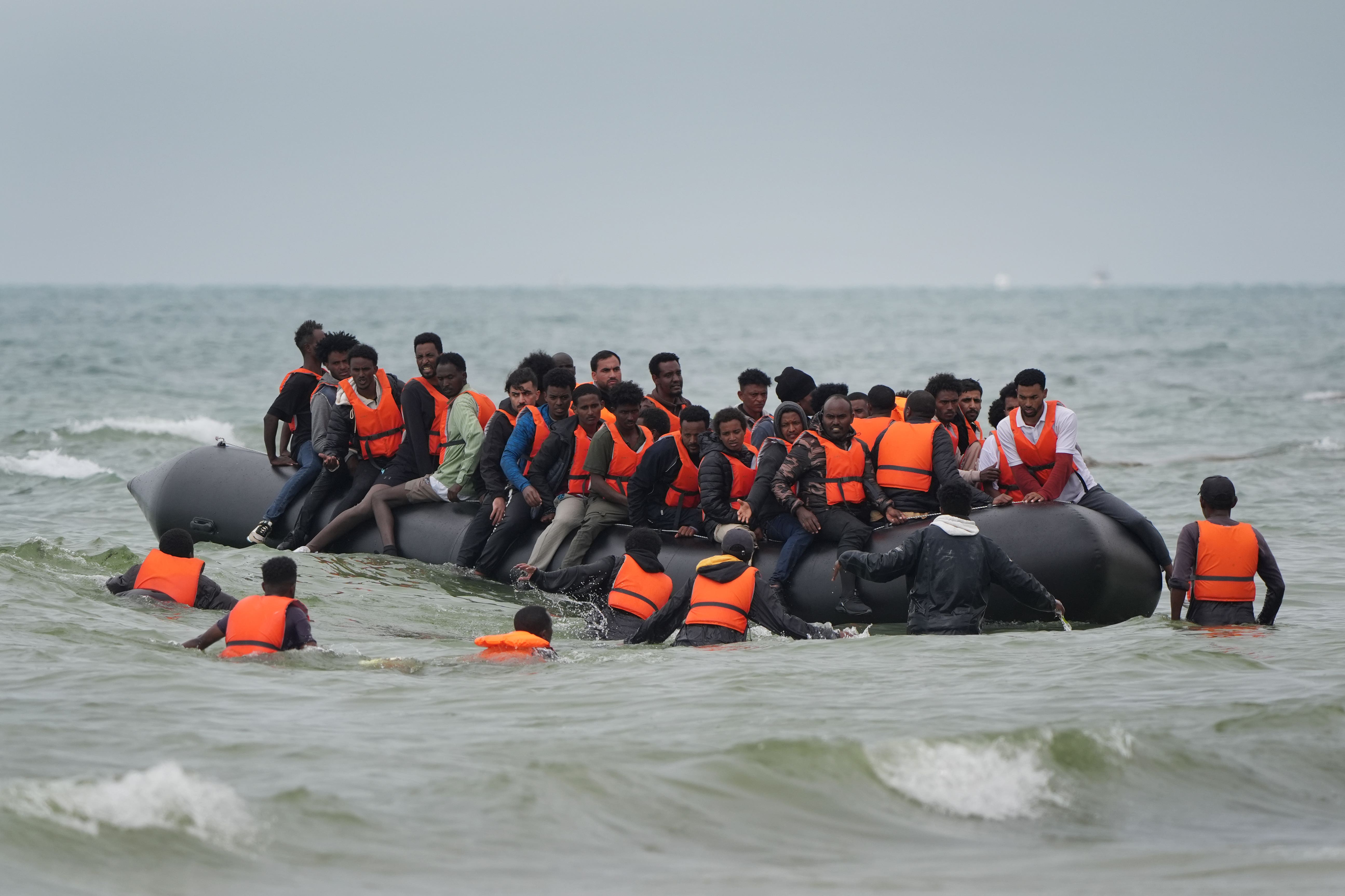 People thought to be migrants scramble to board a small boat near Wimereux in France (PA)