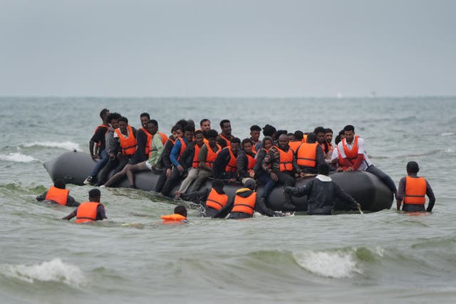 People thought to be migrants scramble to board a small boat near Wimereux in France (PA)