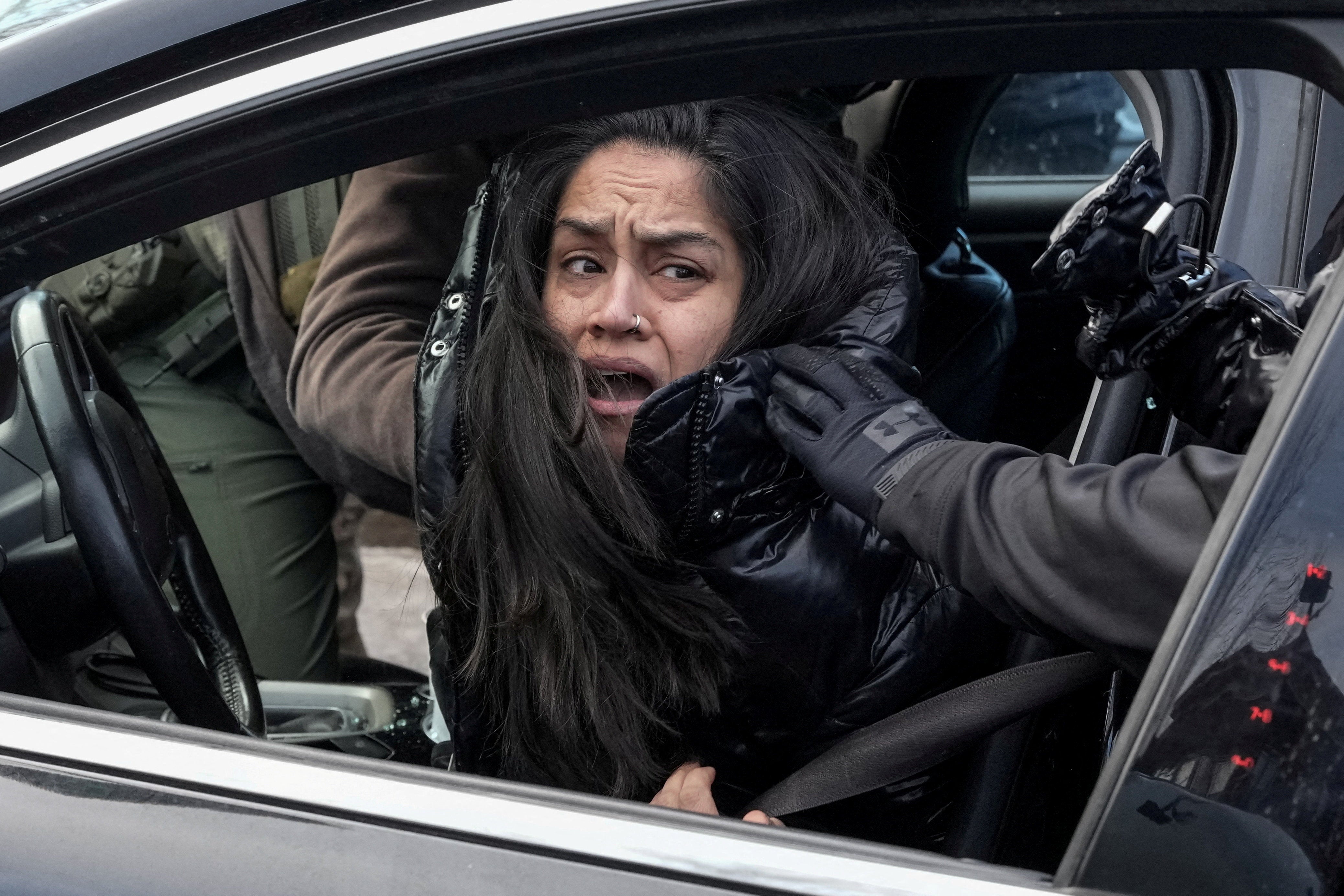 <p>Federal agents grab a woman and drag her away from her car, days after an ICE agent fatally shot Renee Nicole Good, in Minneapolis, Minnesota, on Tuesday January 13, 2026</p>