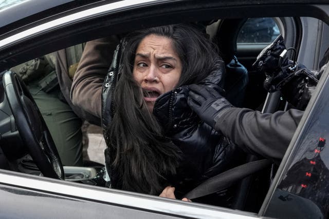 <p>Federal agents grab a woman and drag her away from her car, days after an ICE agent fatally shot Renee Nicole Good, in Minneapolis, Minnesota, on Tuesday January 13, 2026</p>