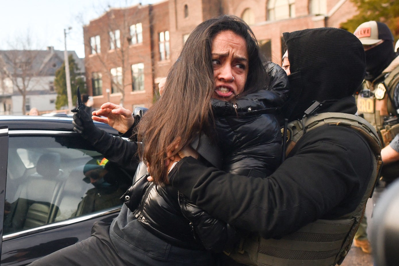 The woman tries to explain that she is disabled and en route to a medical appointment as she is led away and handcuffed