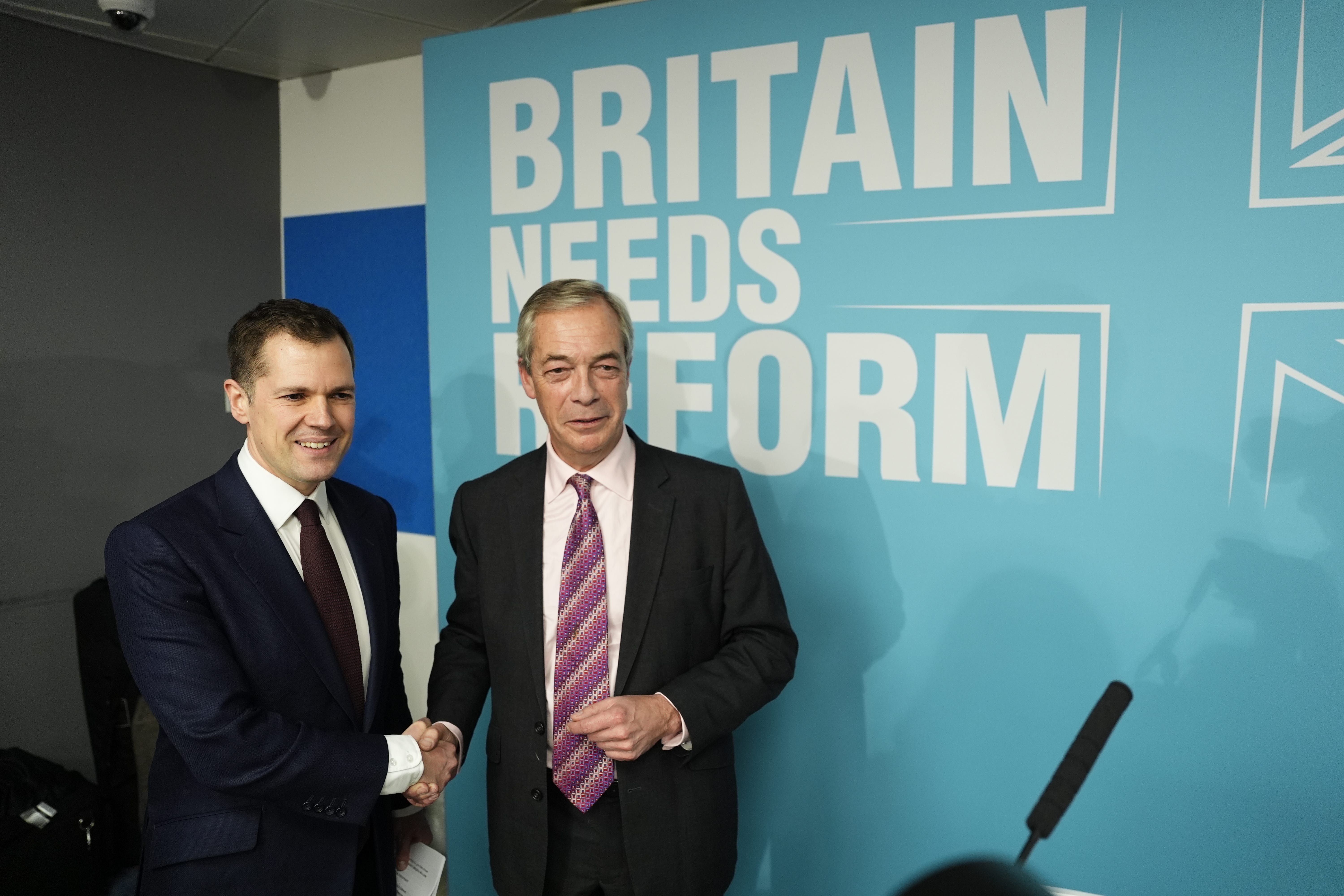 Robert Jenrick with Reform UK leader Nigel Farage at a Reform UK press conference in Westminster (Jordan Pettitt/PA)