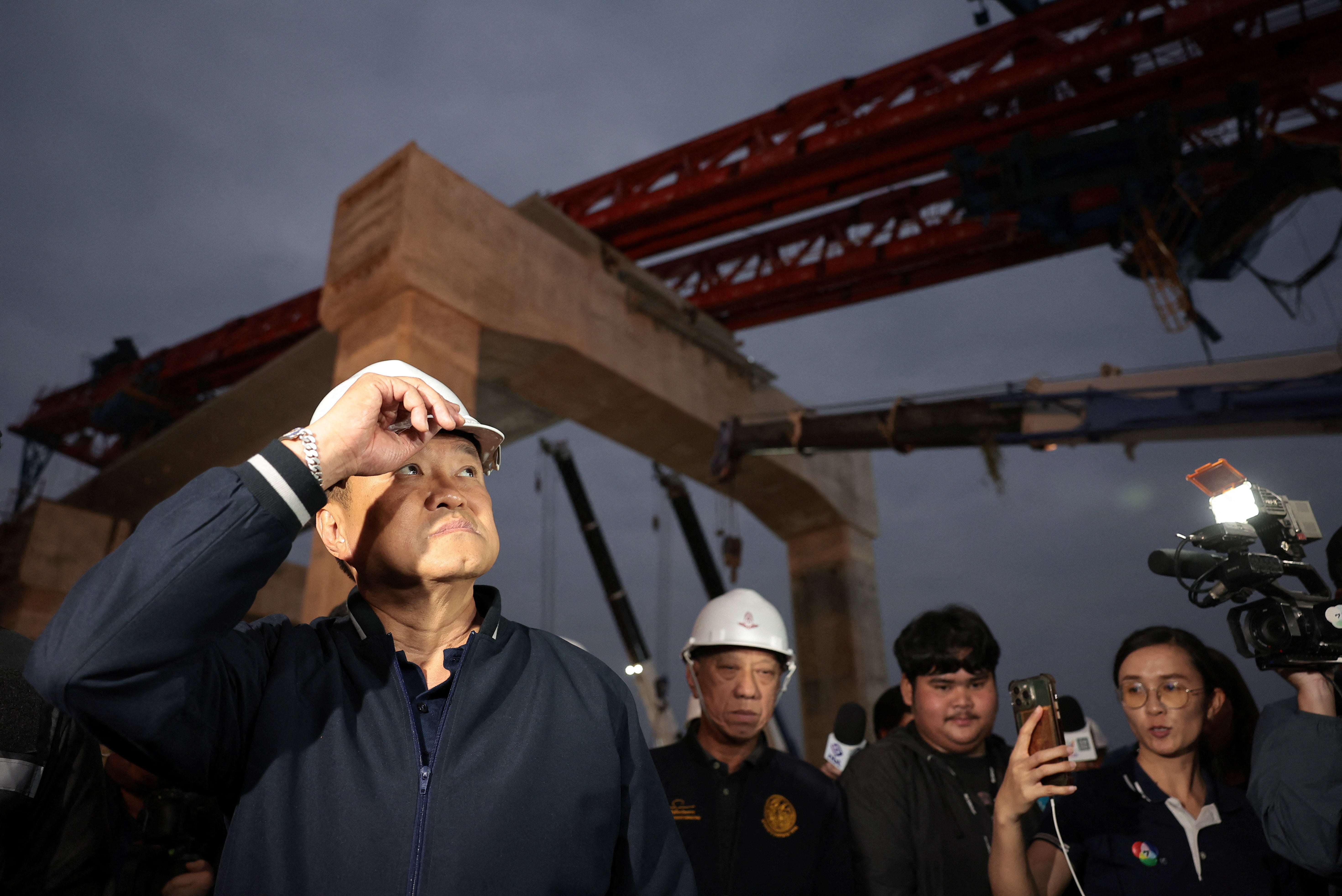 Thailand's caretaker Prime Minister Anutin Charnvirakul, Bhumjaithai Party leader and prime ministerial candidate, visits the site where a train was derailed when a construction crane collapsed and fell onto its carriages, causing several casualties, in Sikhio district