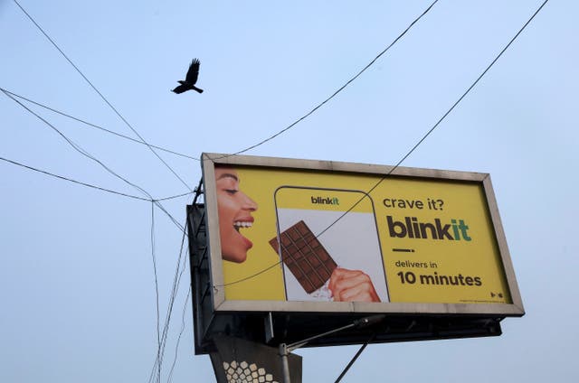 <p>File. A bird flies over a hoarding featuring an ad for Blinkit in Delhi, India</p>