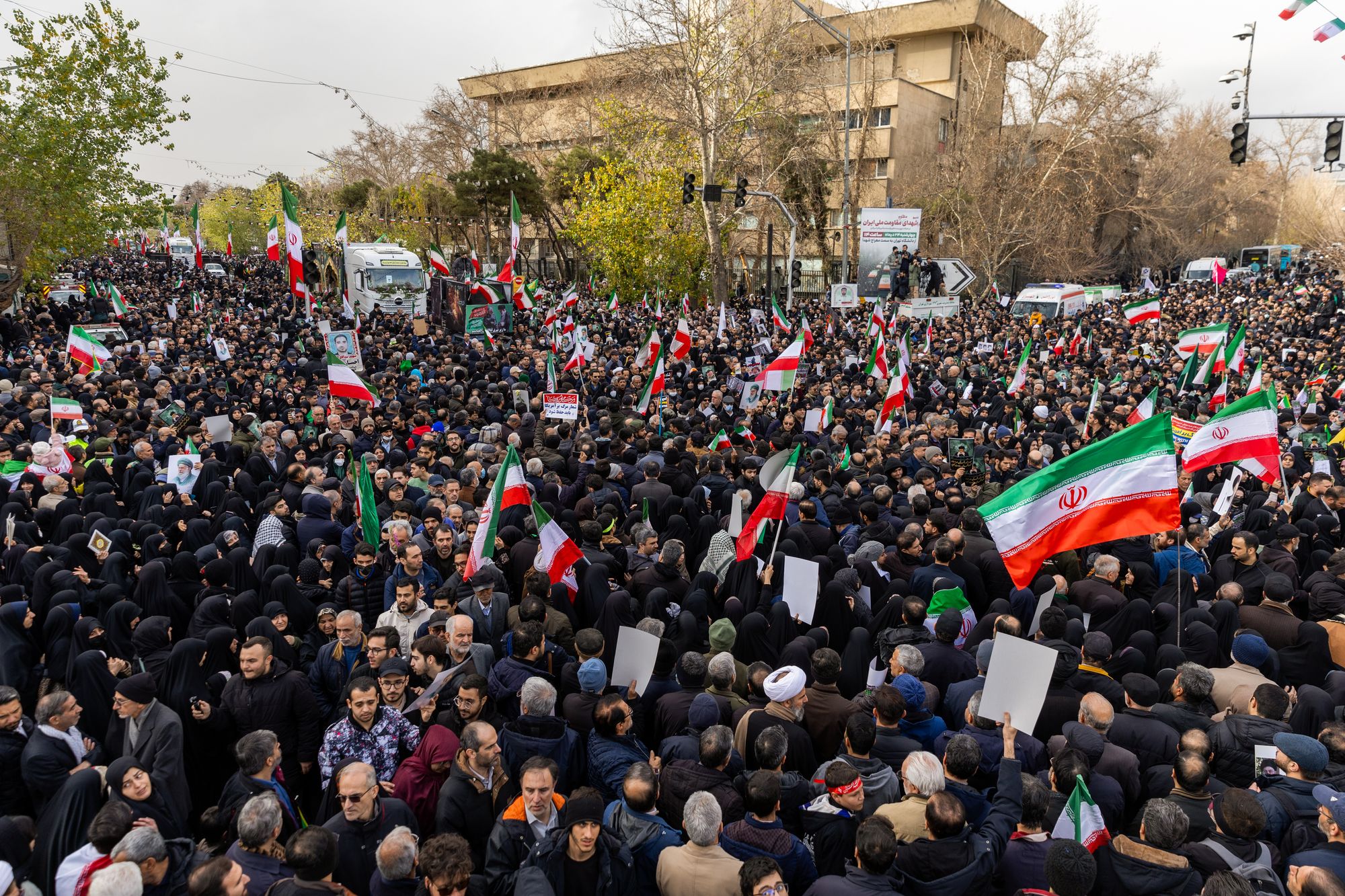 <p>A large crowd gathers during a mass funeral held for over 100 members of the security forces whom authorities said were killed during recent nationwide protests</p>