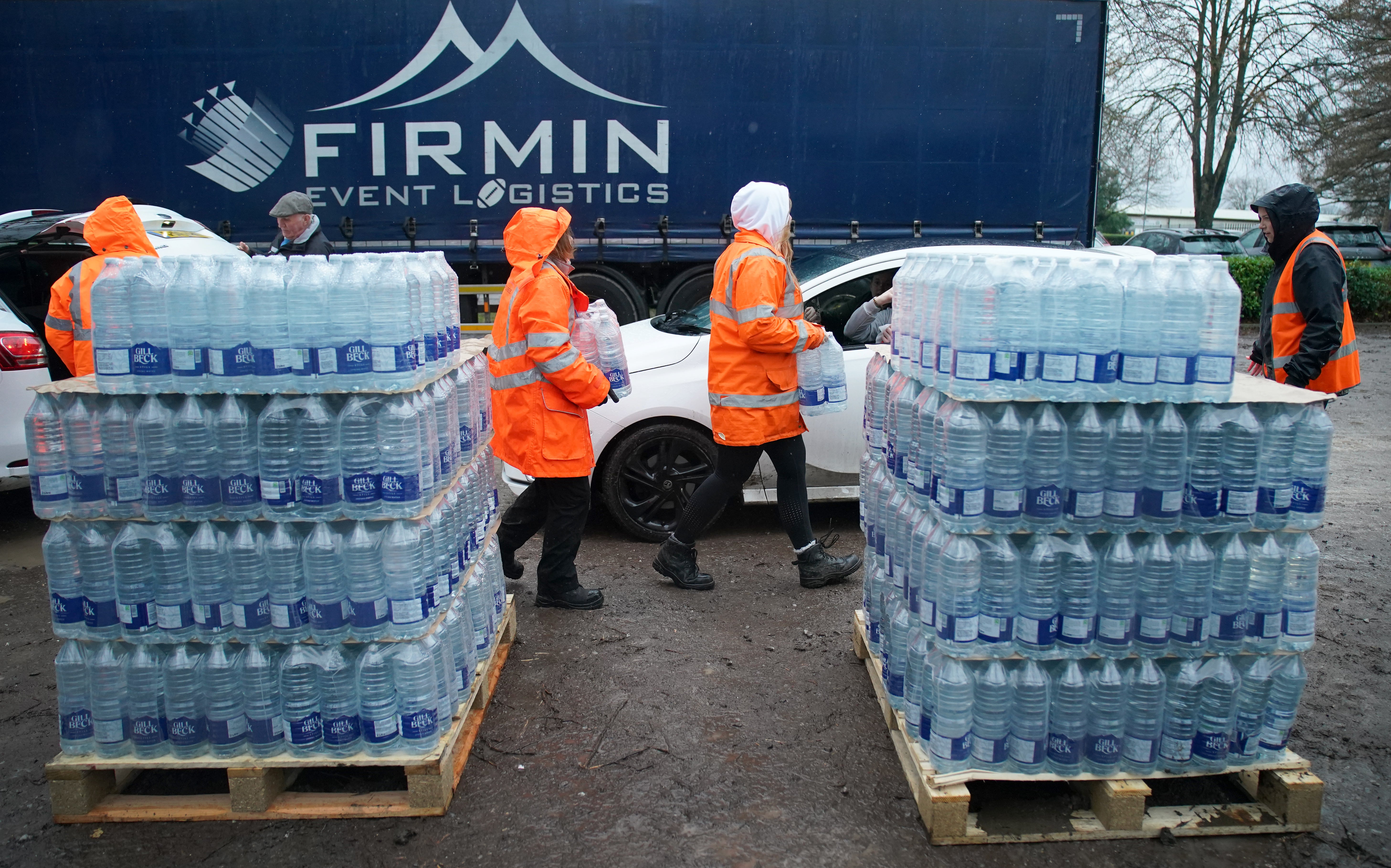 South East Water staff hand out bottled water at a water station in Maidstone, after bad weather was blamed for more water outages in Kent and parts of Sussex (Gareth Fuller/PA)
