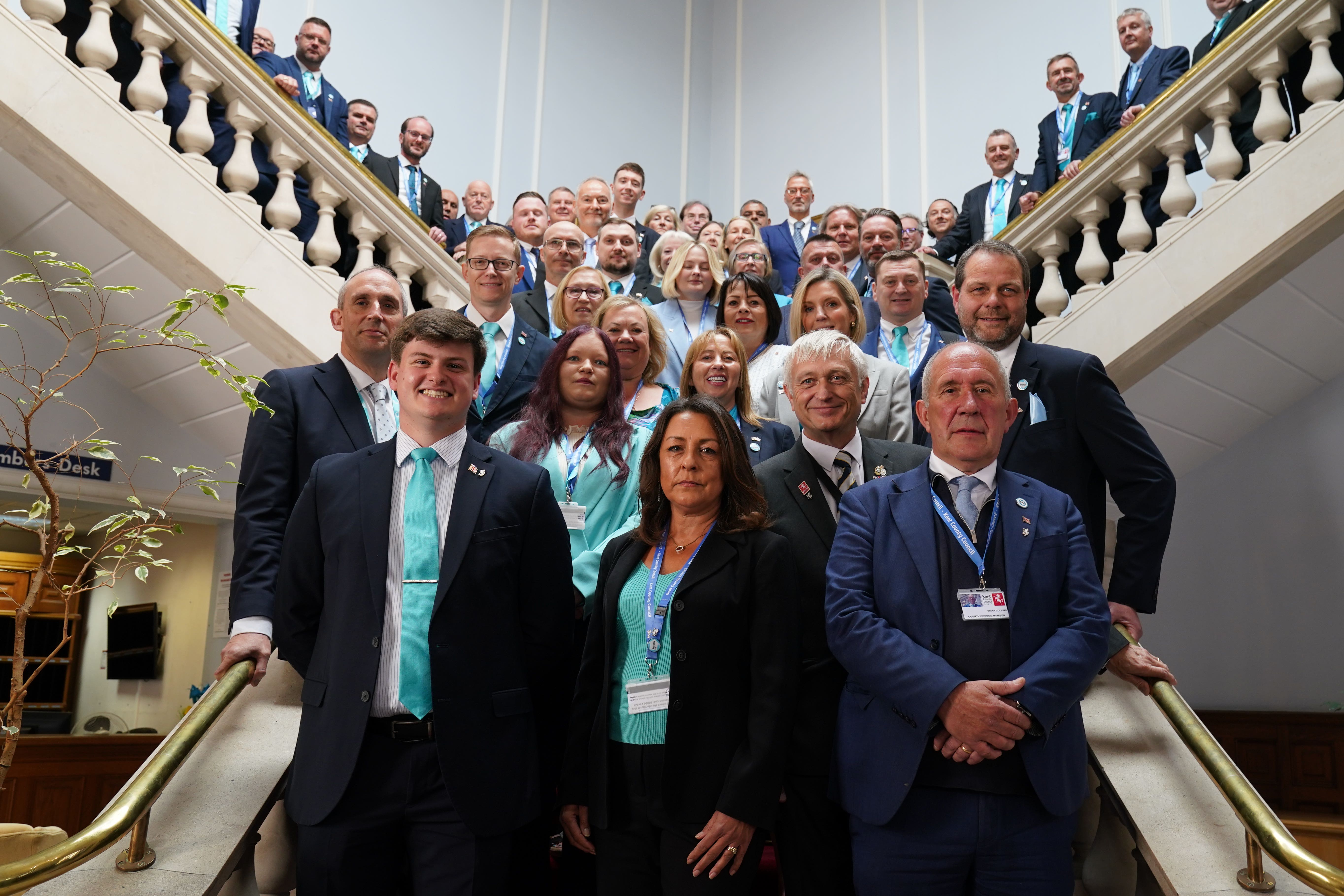Reform Cllr Linden Kemkaran (front centre), leader of the Reform UK Kent County Council group, with the Reform UK councillors elected to Kent County Council, at County Hall in Maidstone, Kent, ahead of the first full council meeting (PA)