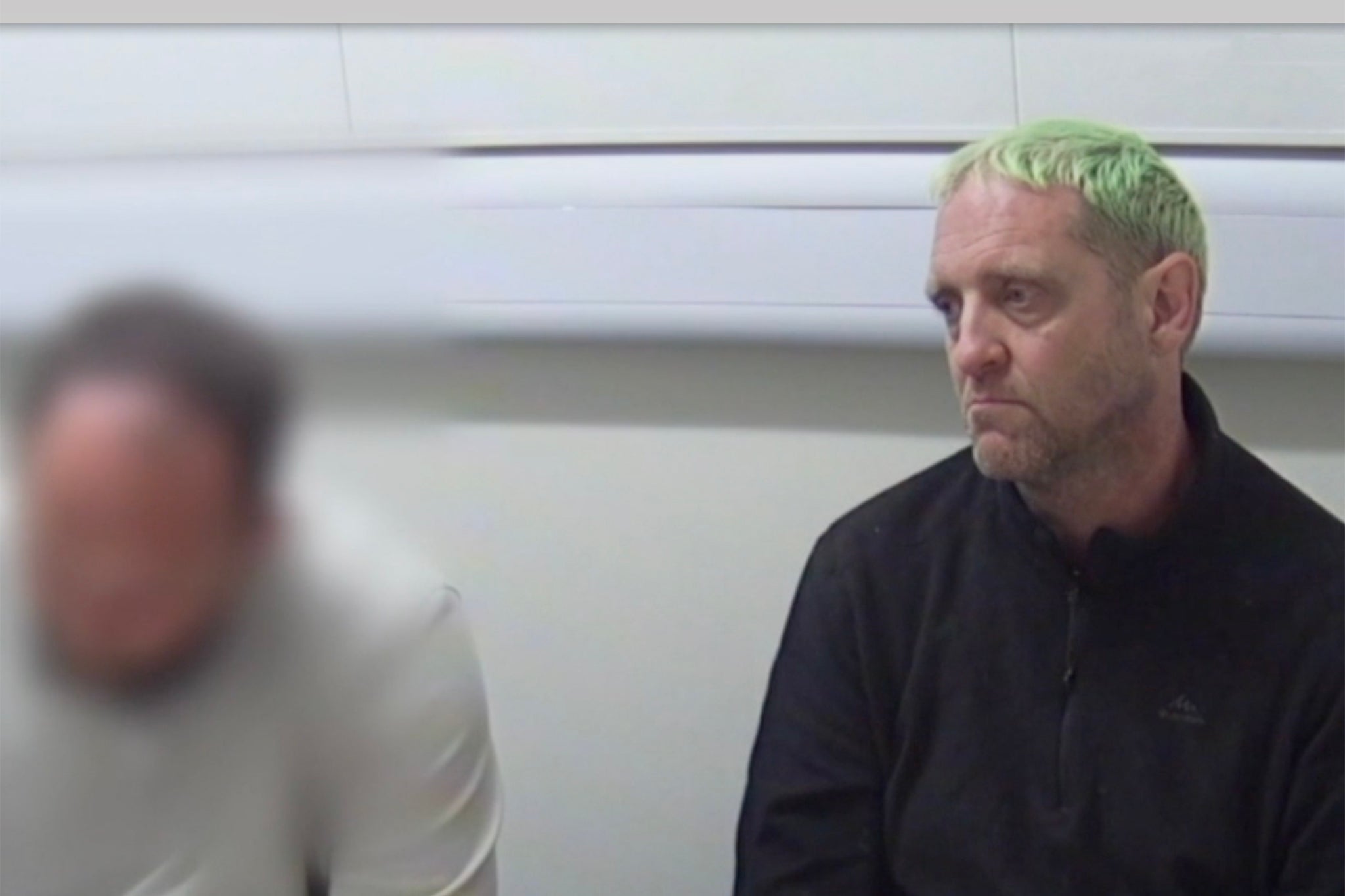 Rhodes pictured during a police interview. He maintains his innocence